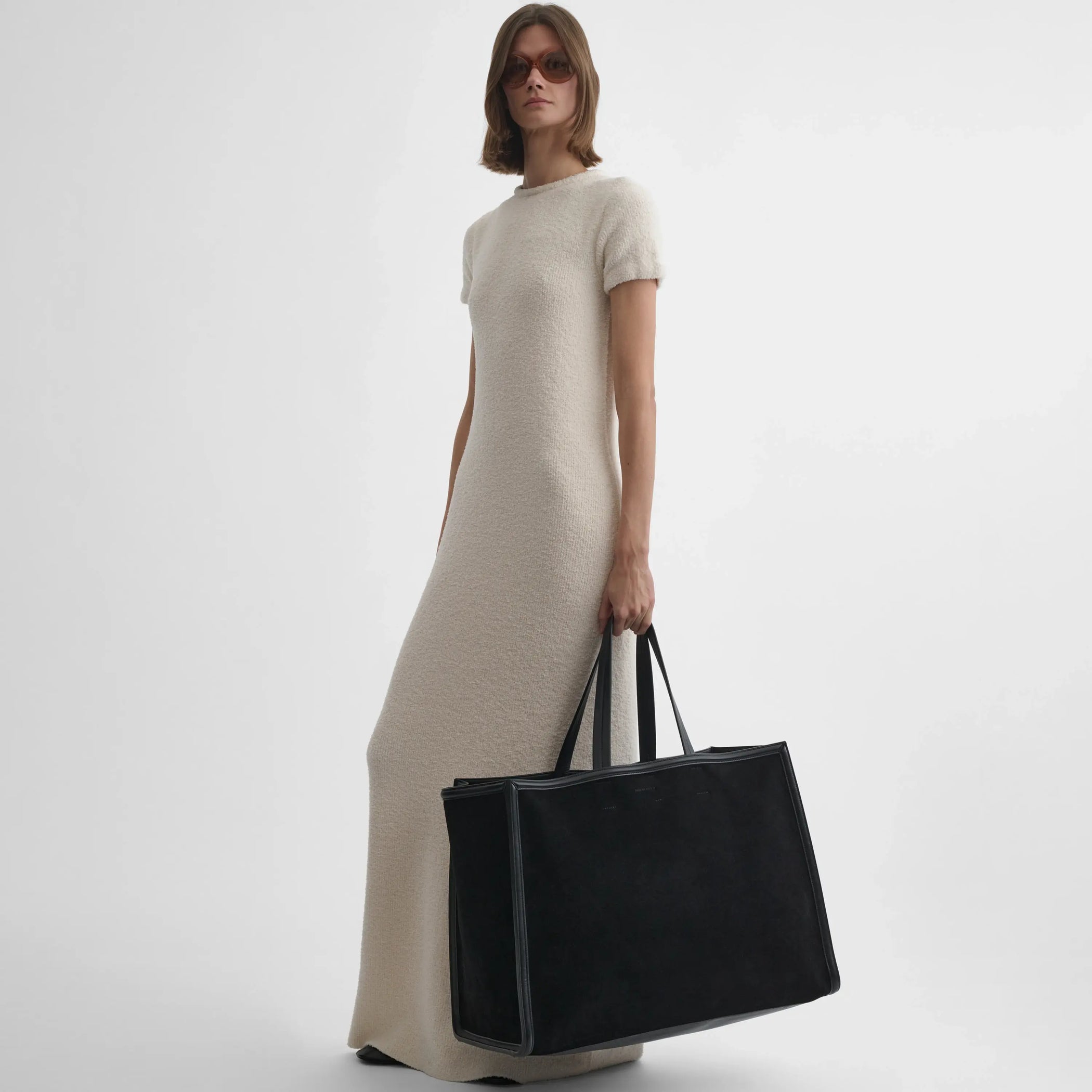 Model holding XL cabas in black suede