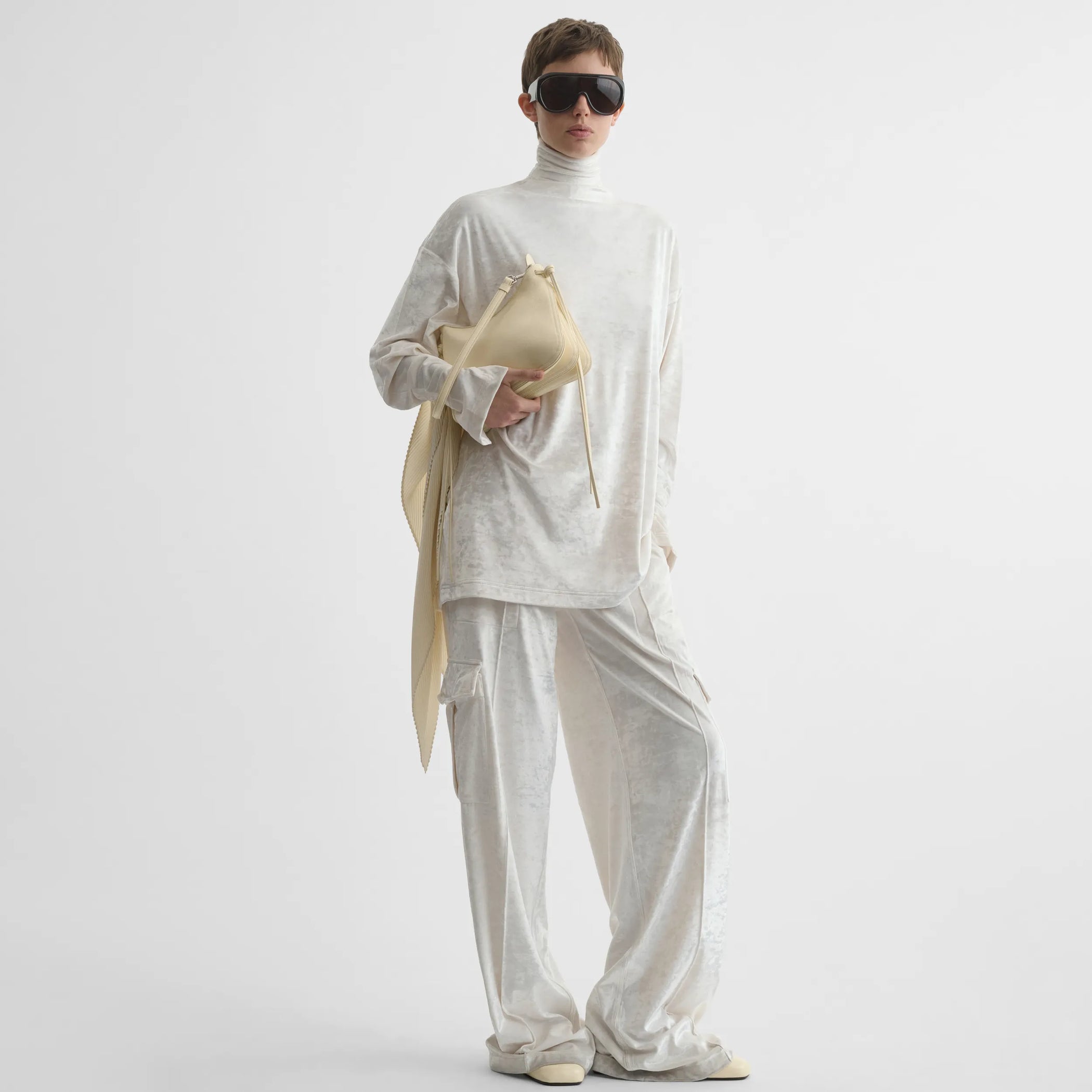 Front view of model holding small gig in stucco leather.