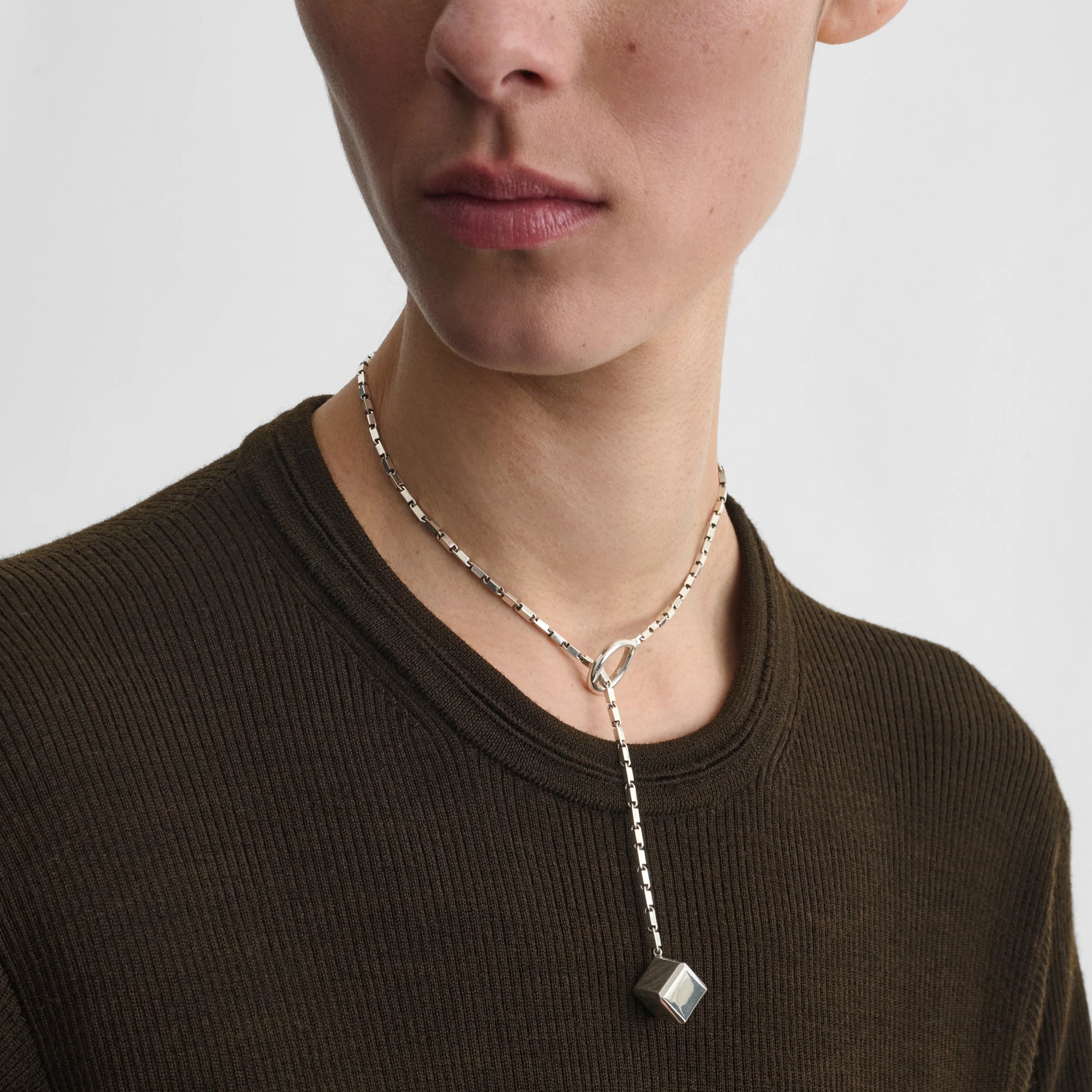 Front view of model wearing hoop tie pendant in sterling silver.