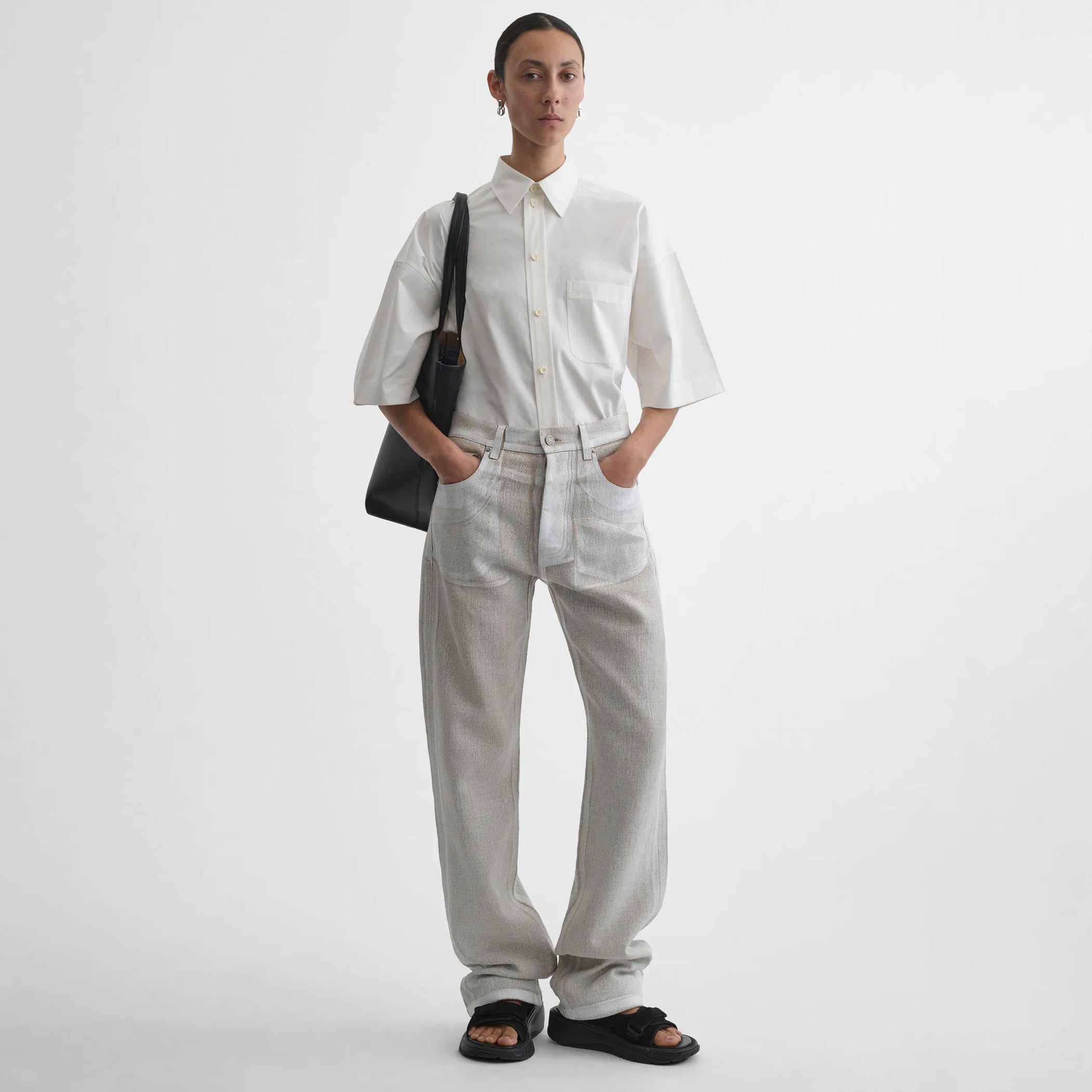 Front view of model wearing the classic jeans in hay