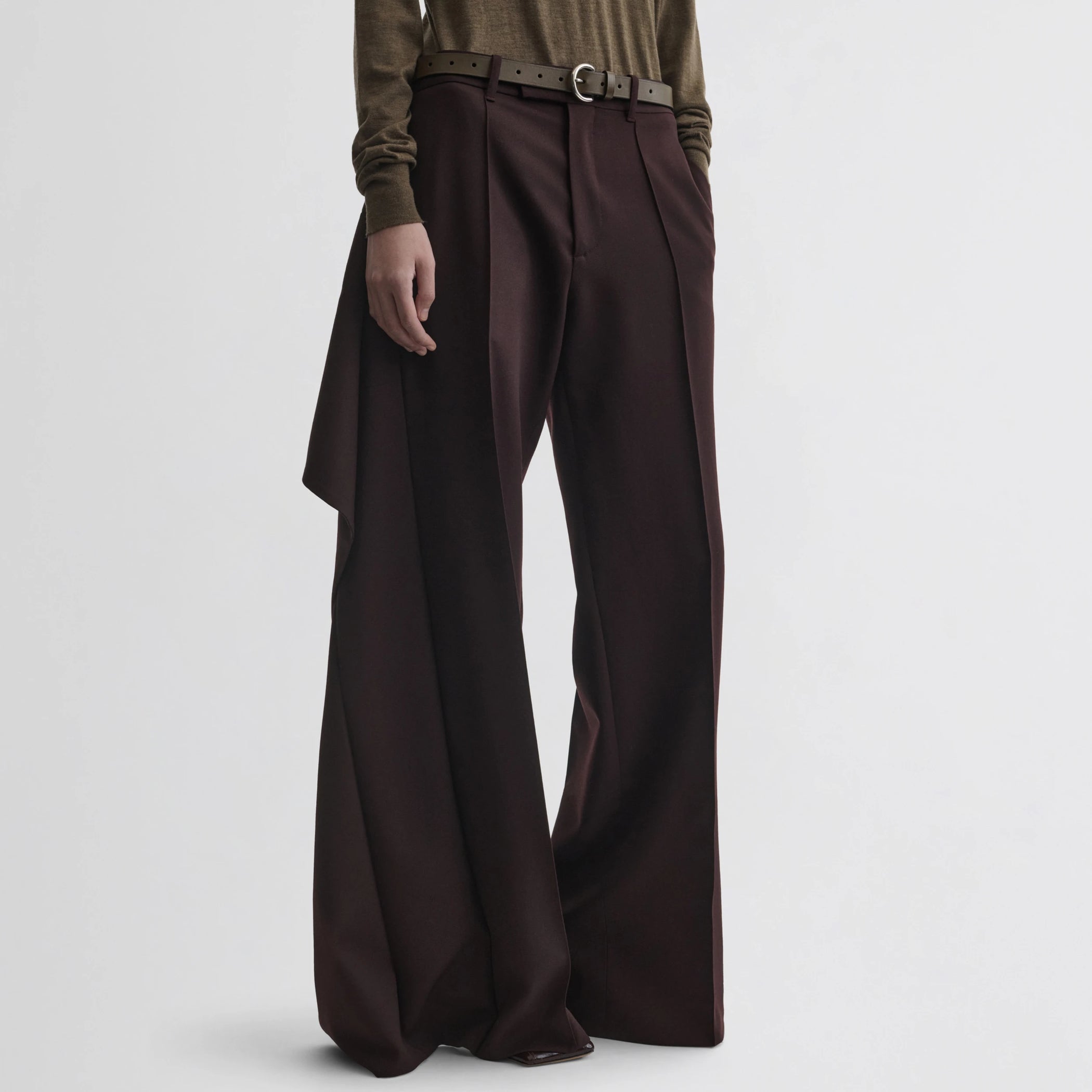 Front view of model wearing apron trousers in chocolate wool.