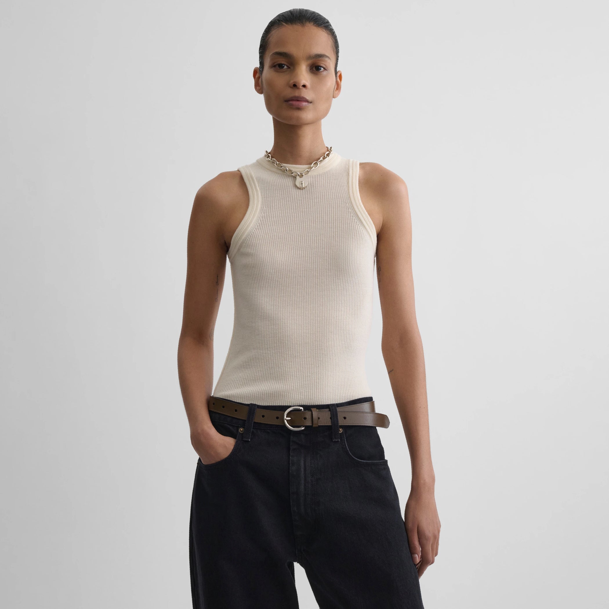 Front view model wearing light merino wool rib tank top in cream