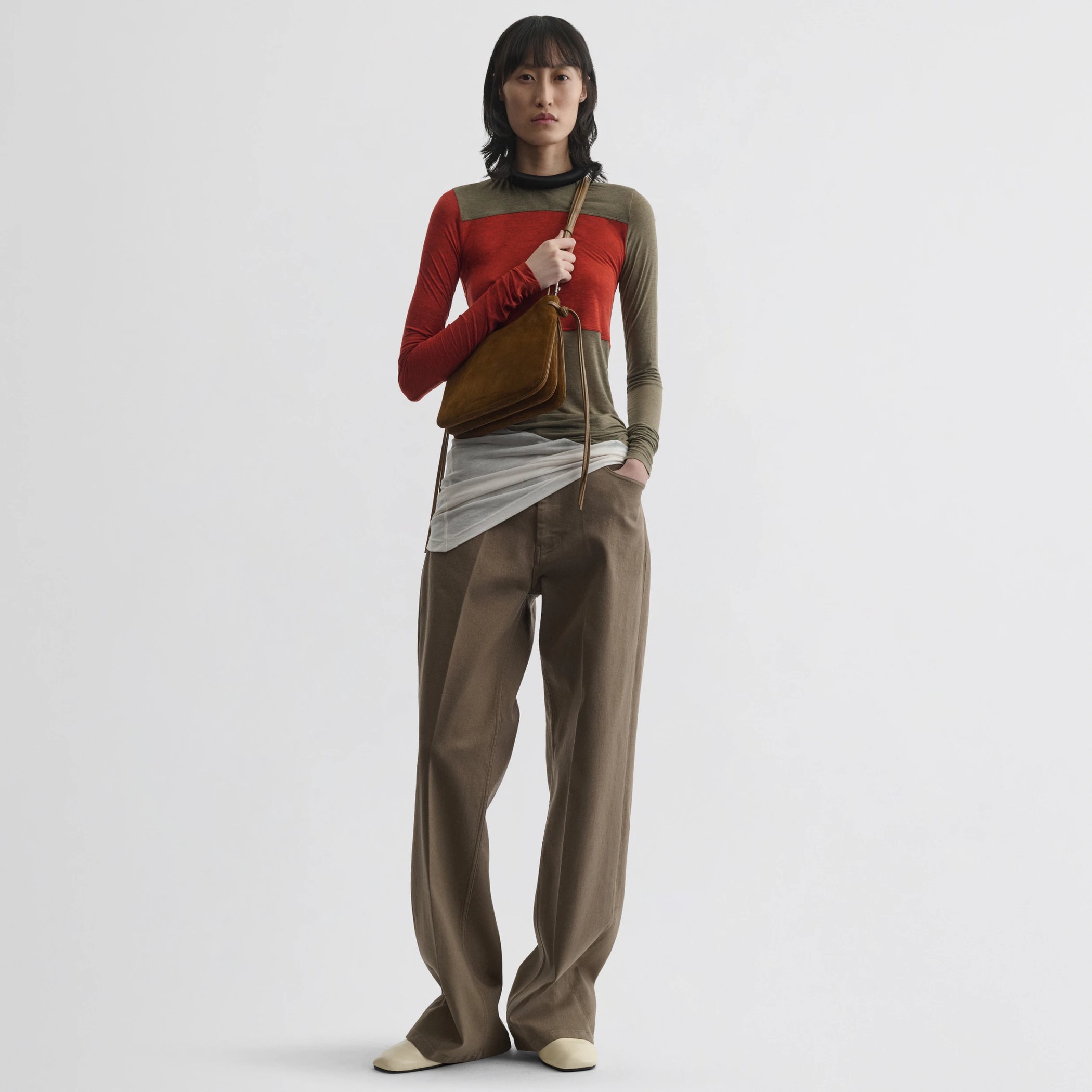 Front view of model wearing tubular colour block top in ivory tobacco red cotton.