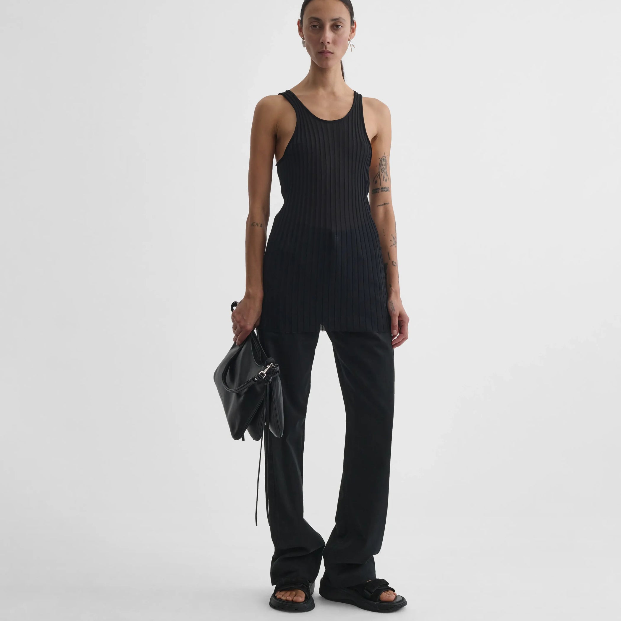 Model holding Gig bag in black leather. 