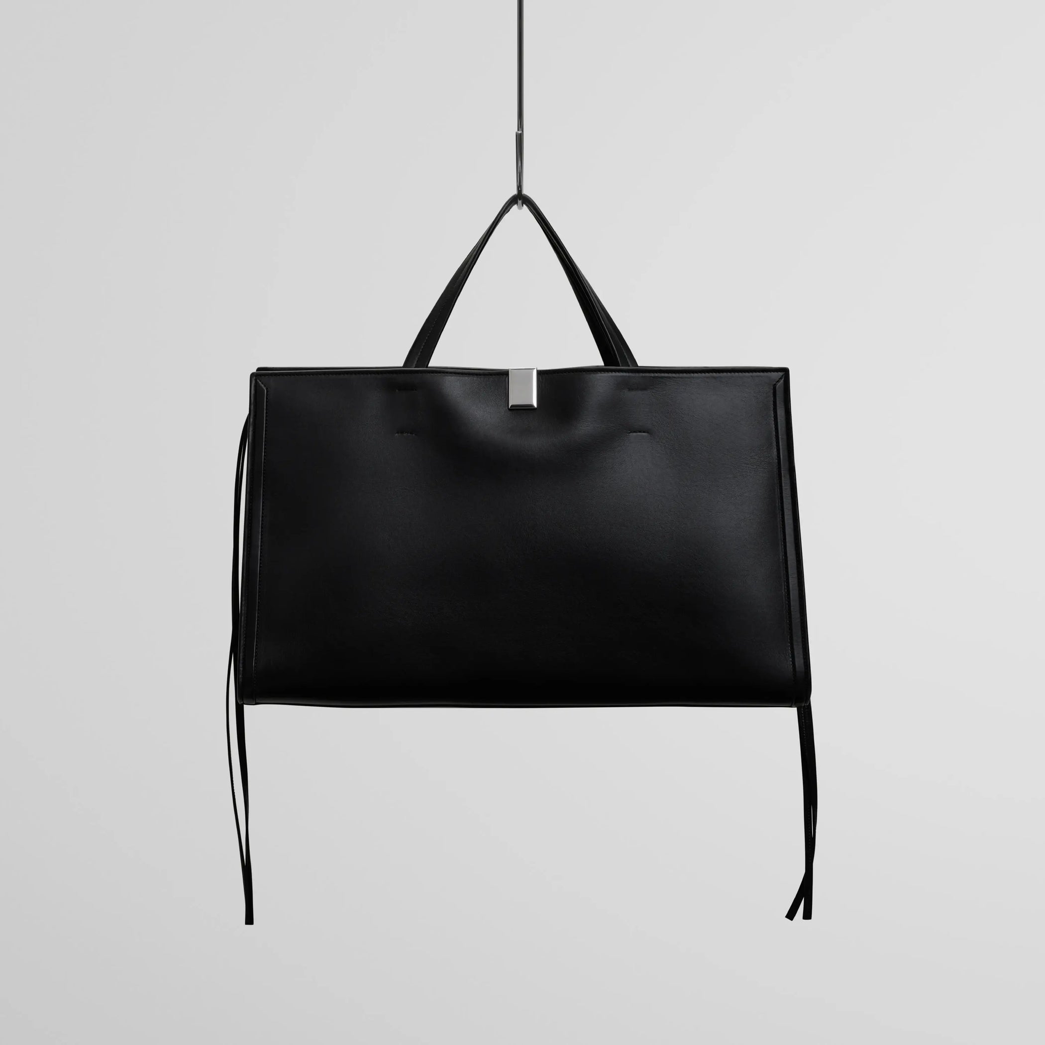 Front view of medium kit cabas in soft calf black leather with silver colour hardware.