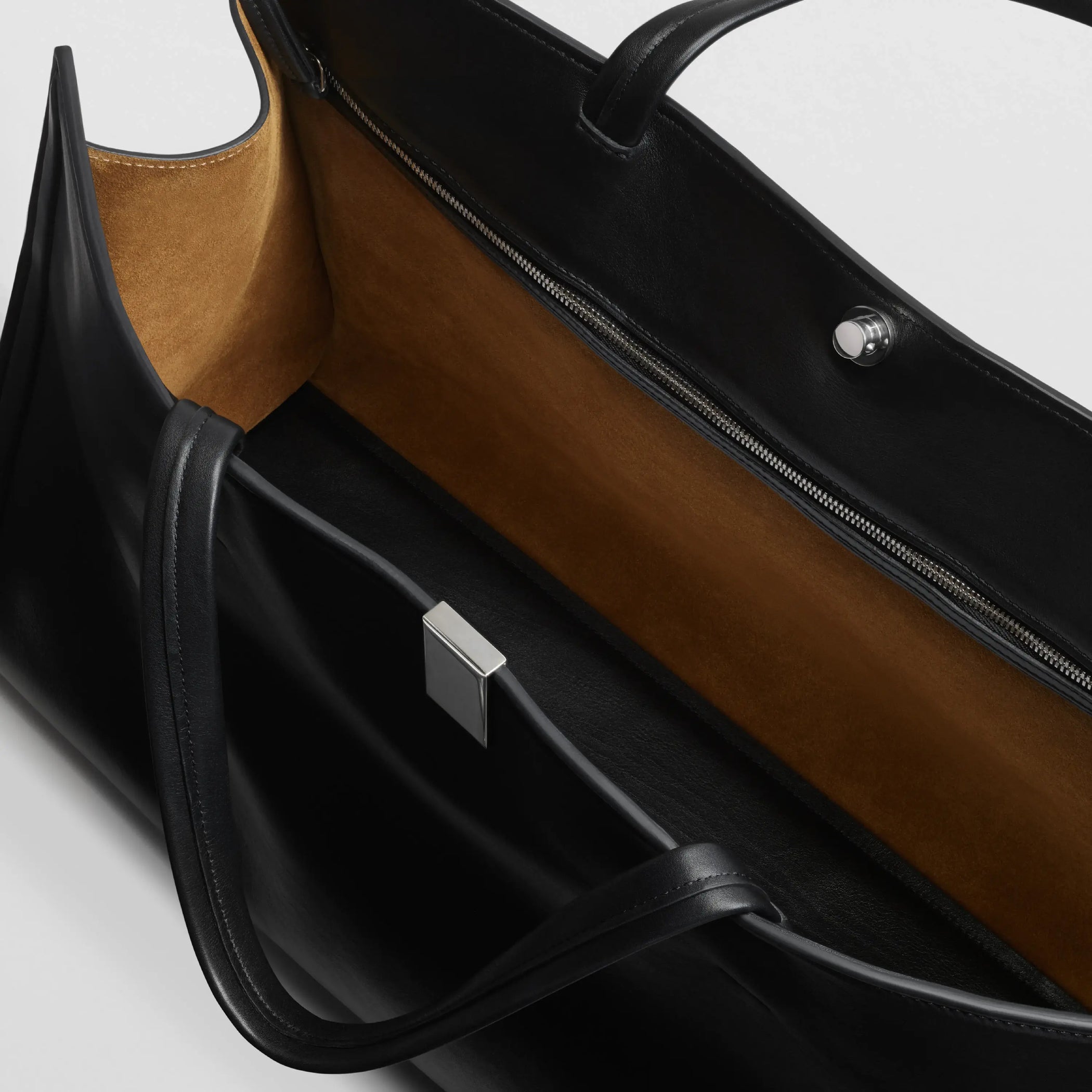 Interior detail view of medium kit cabas in soft calf black leather with silver colour hardware.