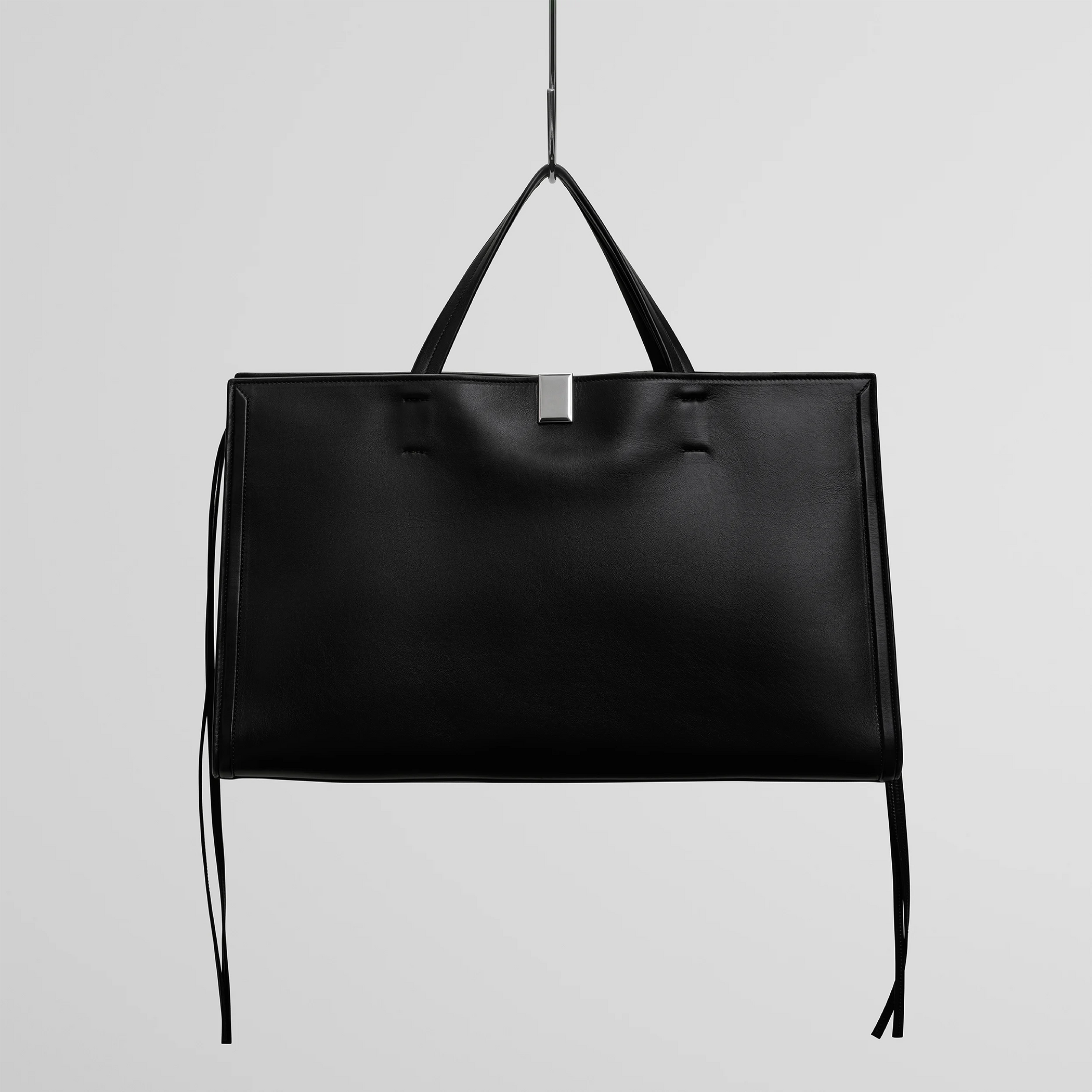 Front view of medium kit cabas in soft calf black leather with silver colour hardware.