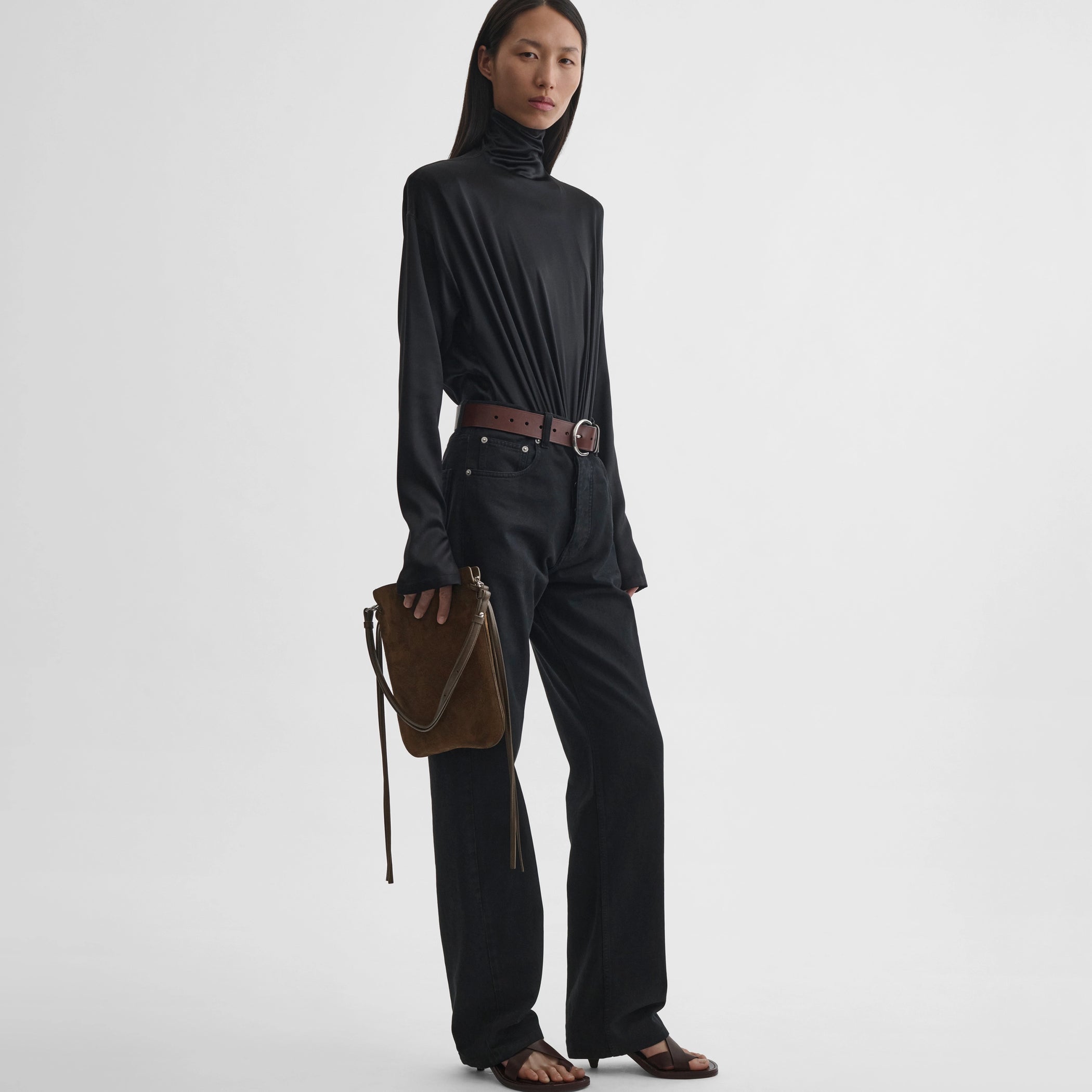 Front view of model wearing gig pouch in khaki leather 
