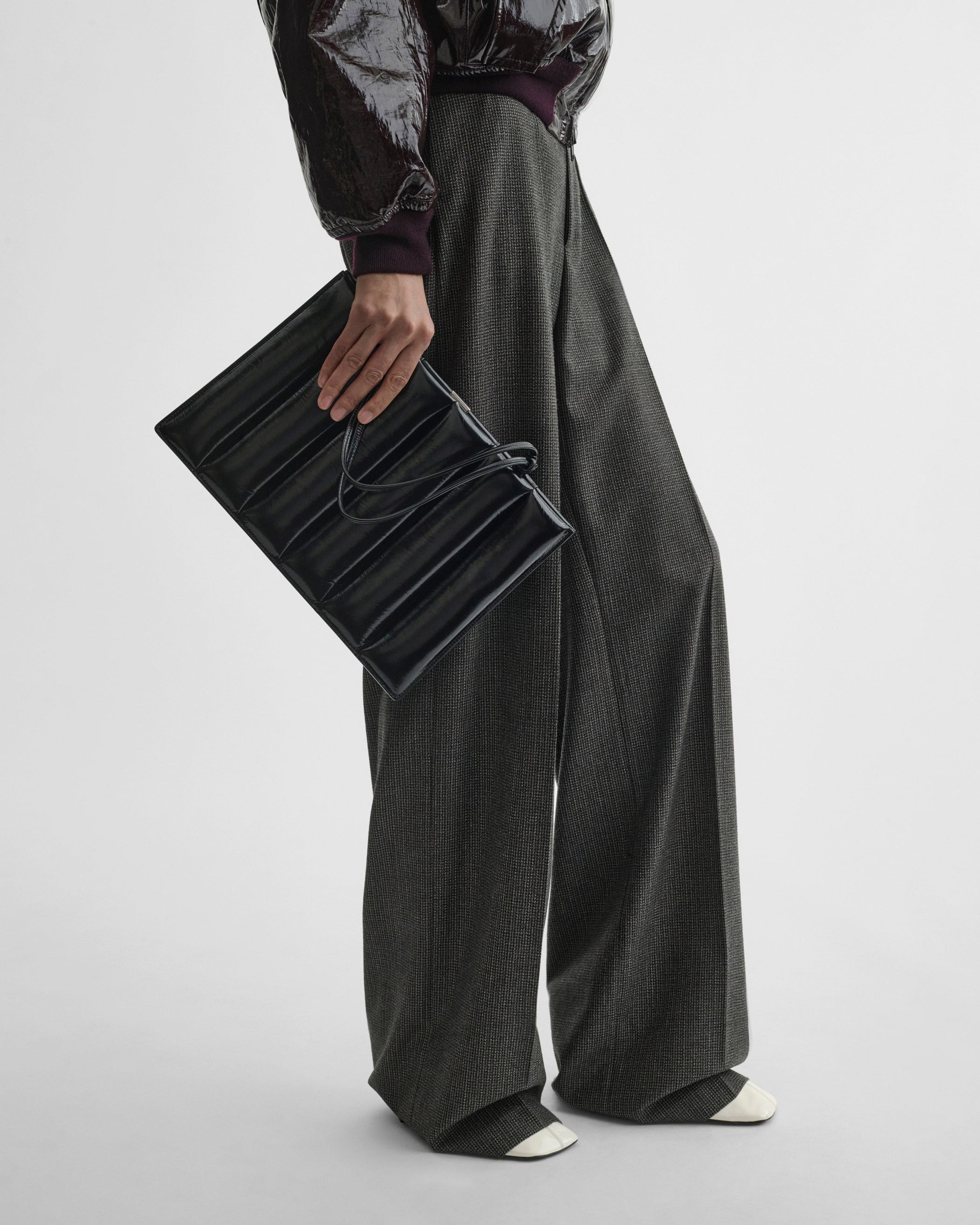 Model holding the DRIVE BAG in black leather