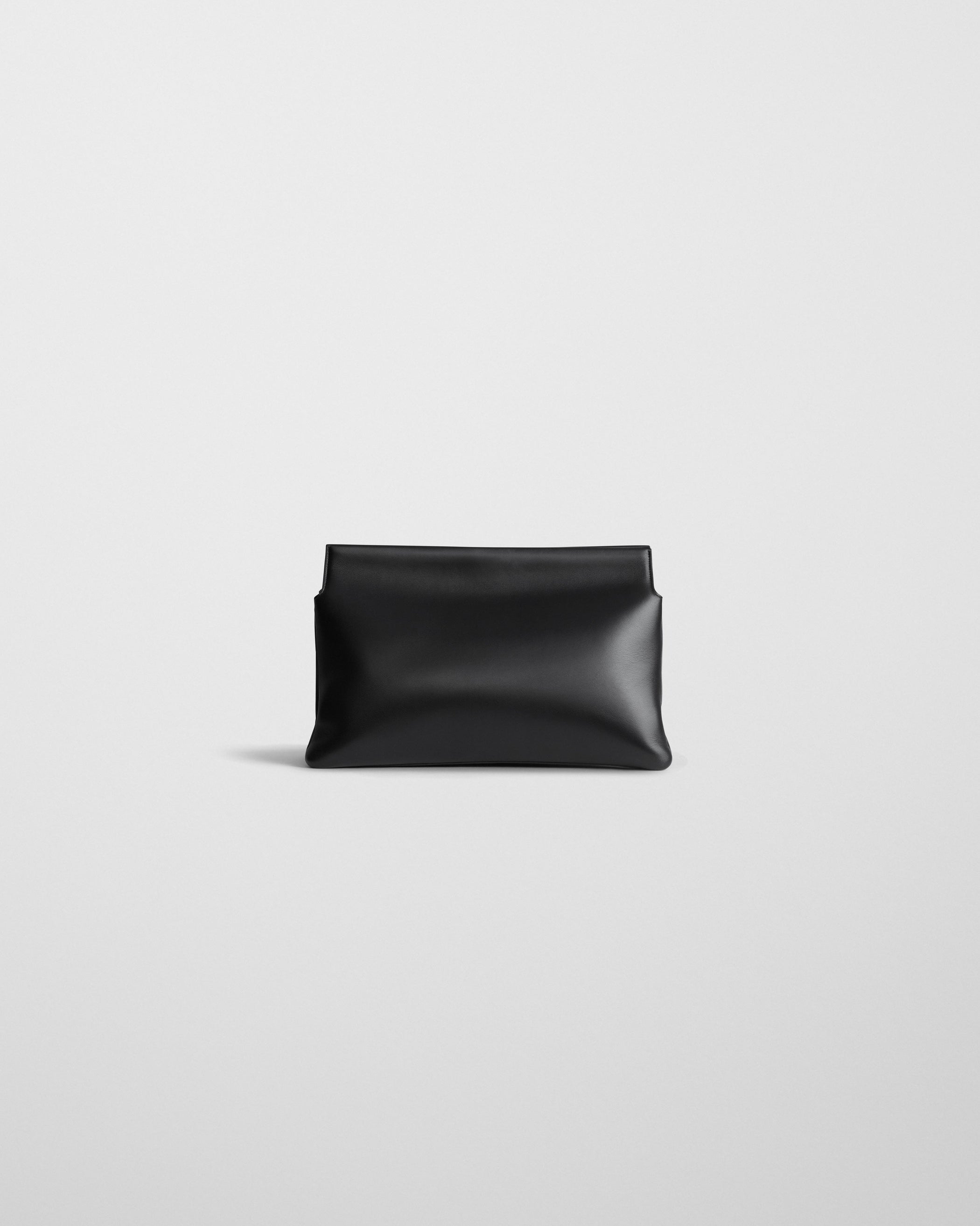 Back view of TRIPLEX CLUTCH BAG in black leather
