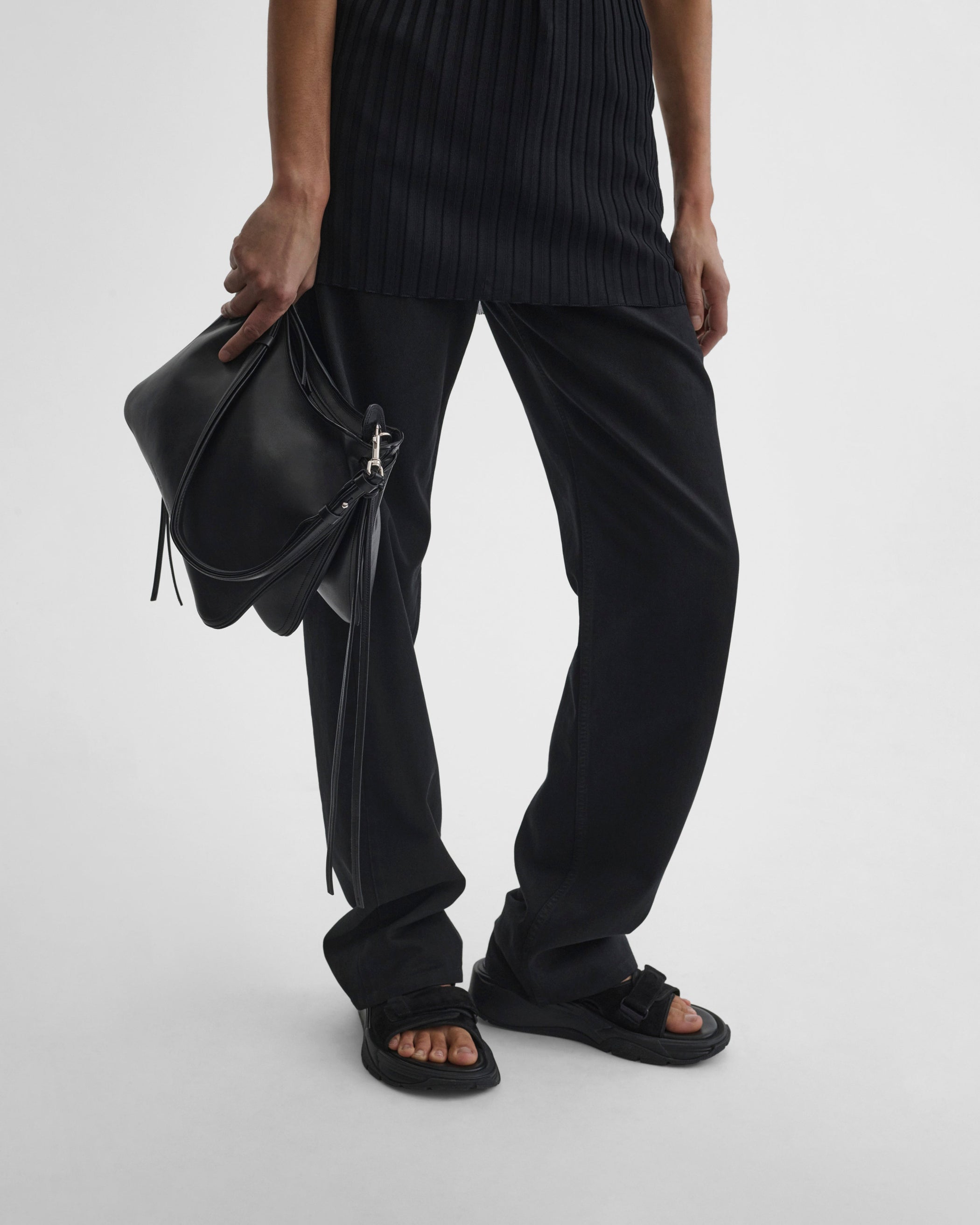 Model holding GIG BAG in black leather