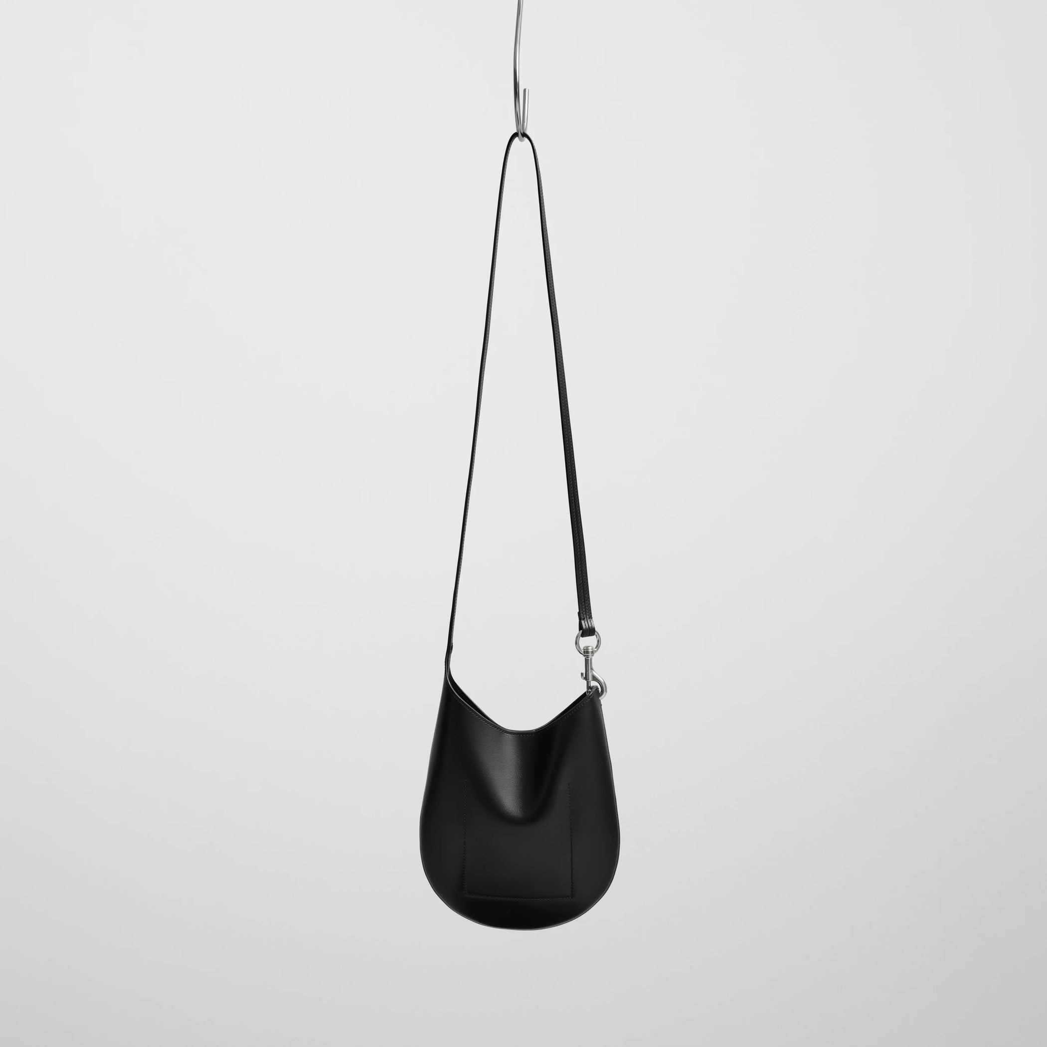 Back view of mini bean sling in black leather.