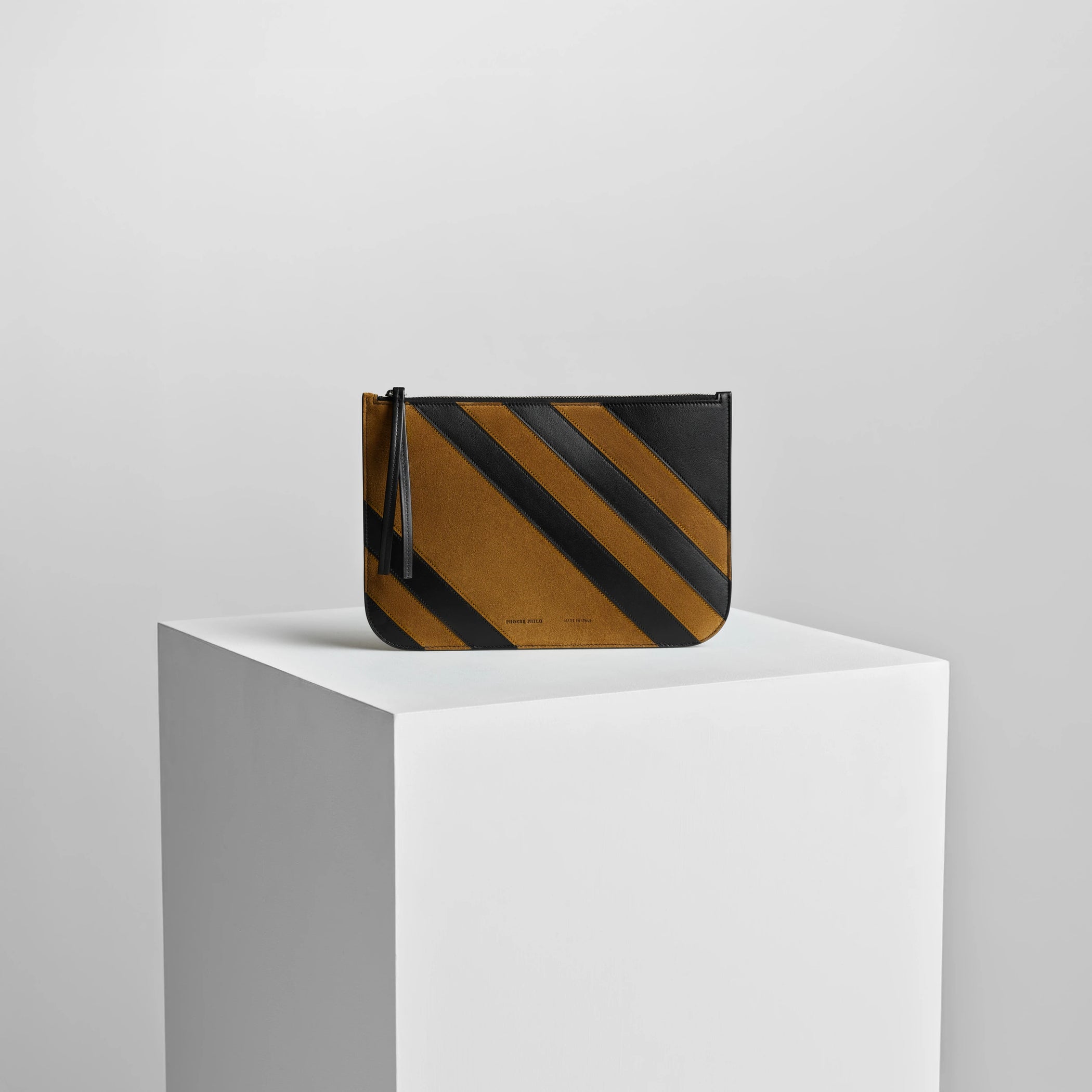 Front view of pocket pouch in toffee/black leather.
