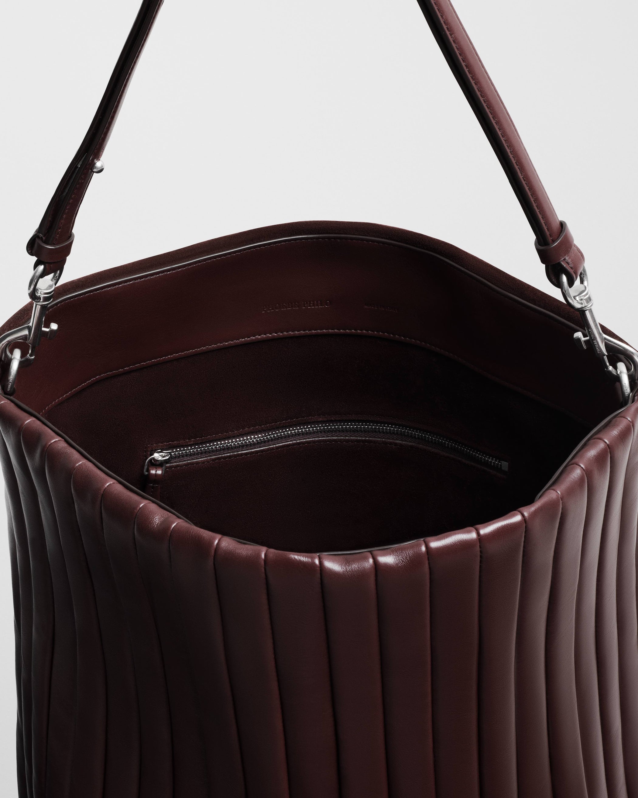 Close up view of the ACCORDION BAG in oxblood leather