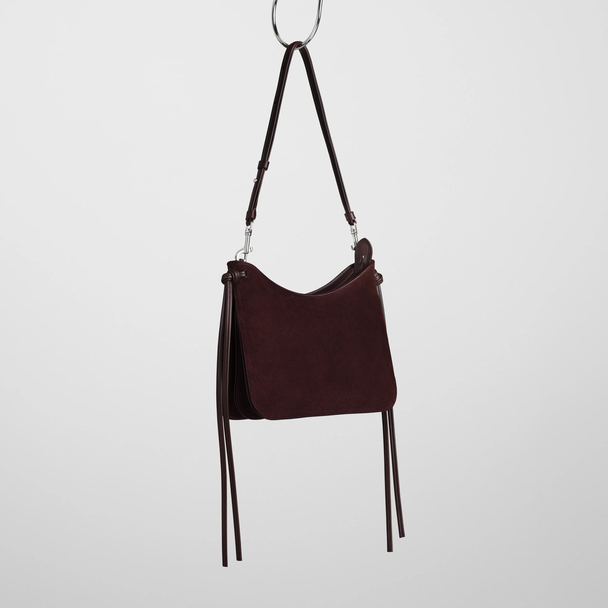 Side view of small gig bag in oxblood suede leather.
