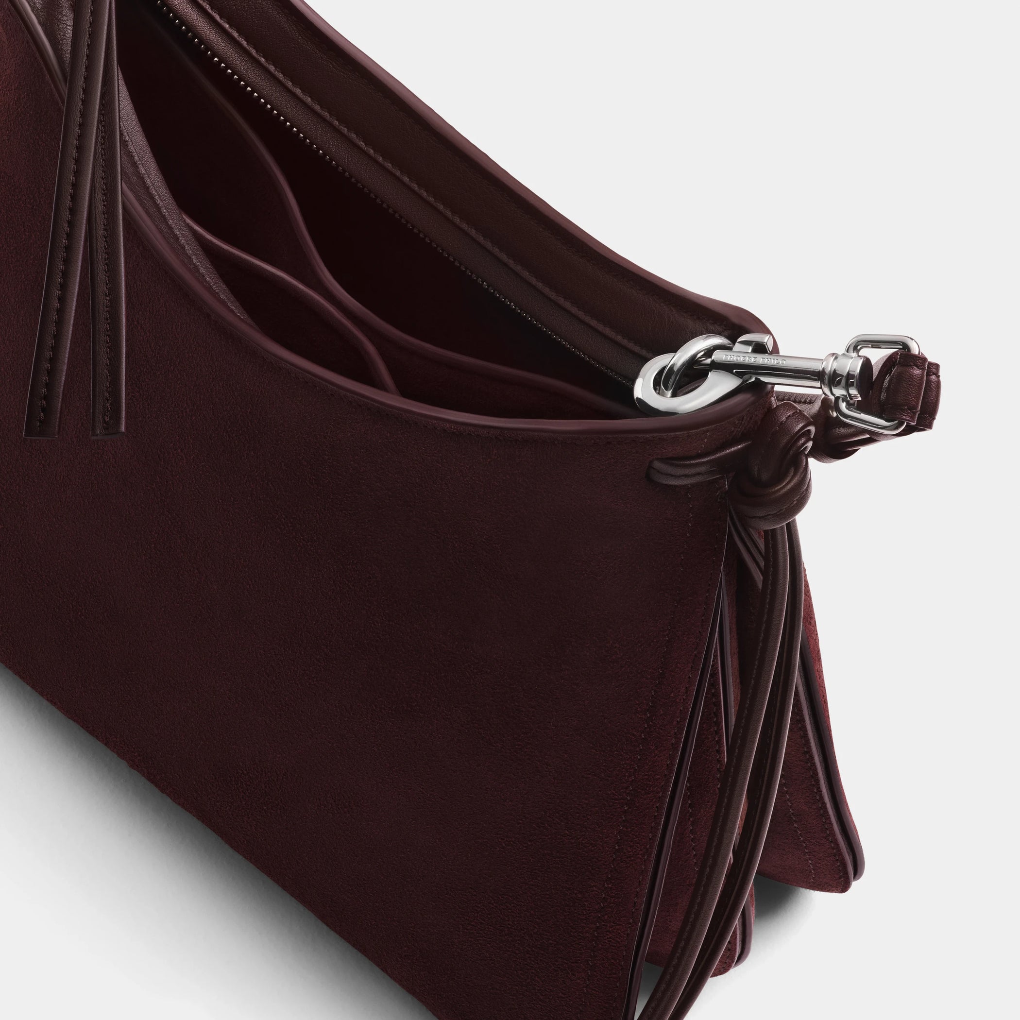 Close up detail view of small gig bag in oxblood suede leather.