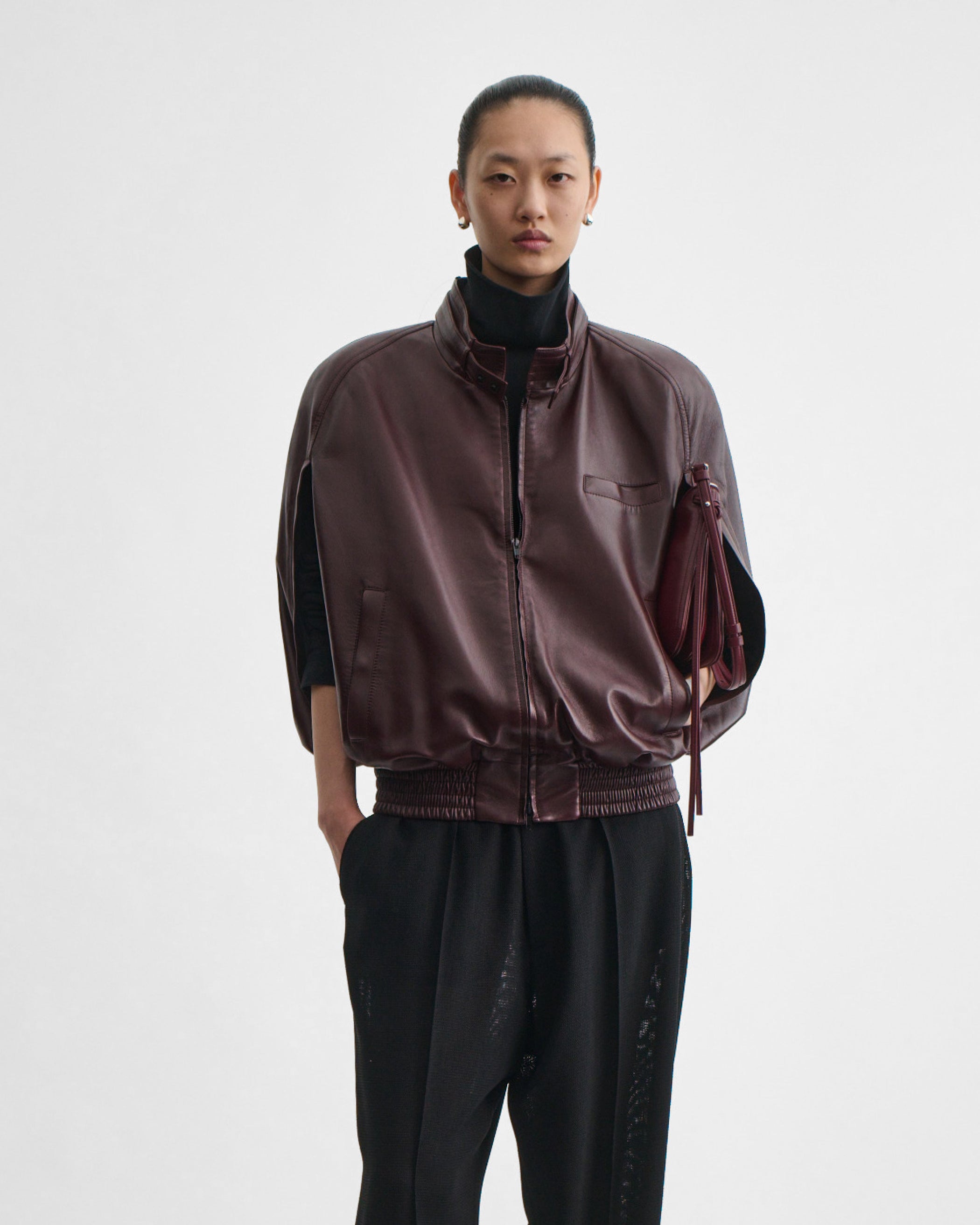 Model holding SMALL GIG BAG in lava leather