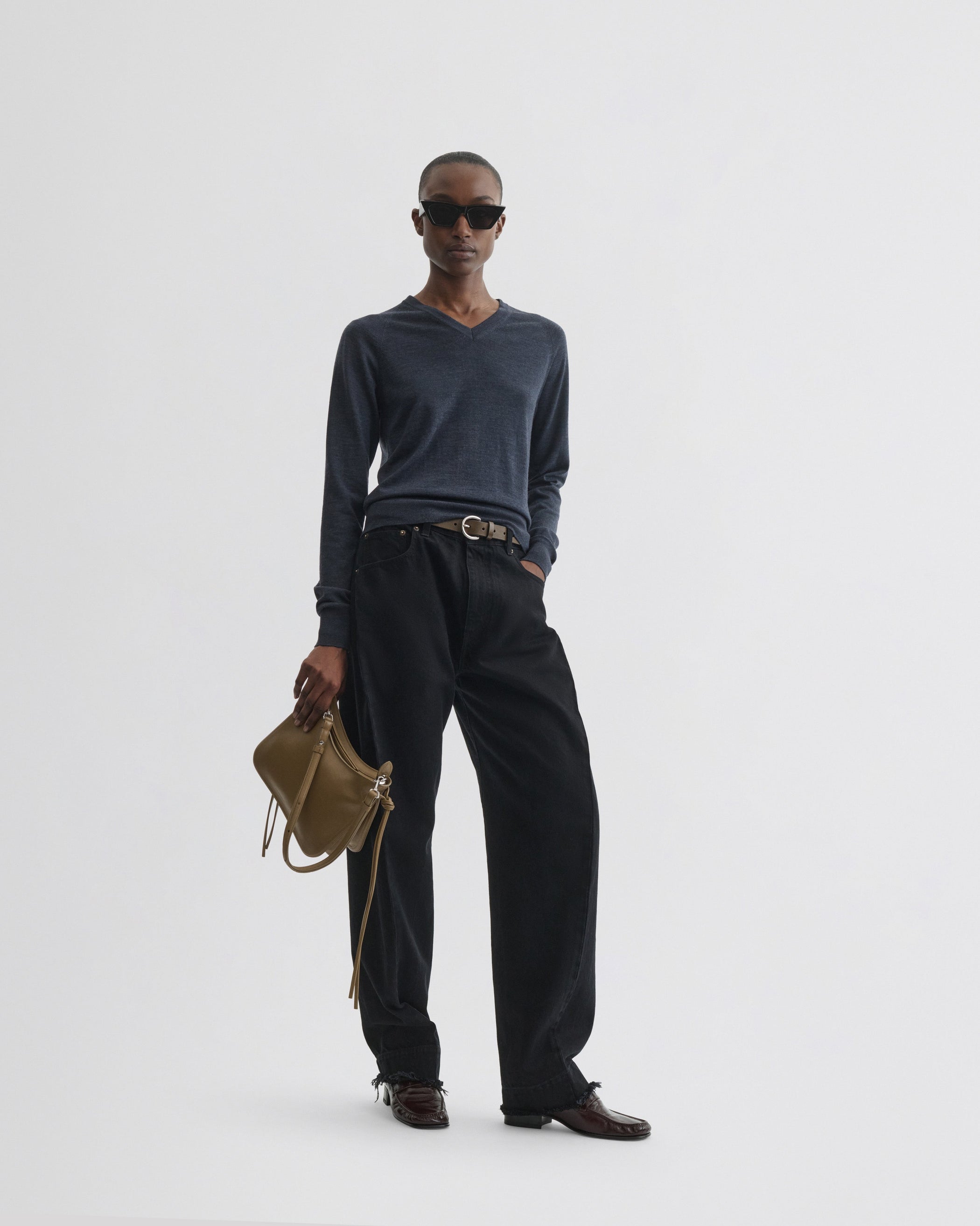 Model holding SMALL GIG BAG in cookie leather