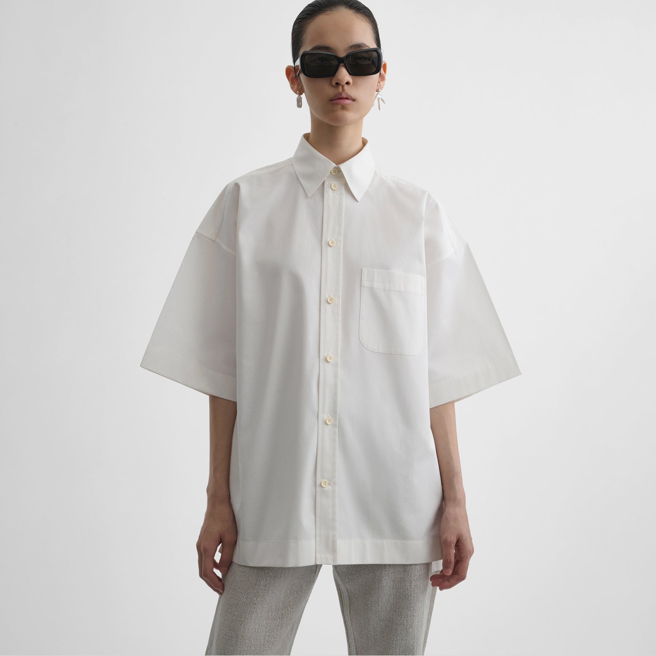 Front view of model wearing short sleeve shirt in vanilla cotton