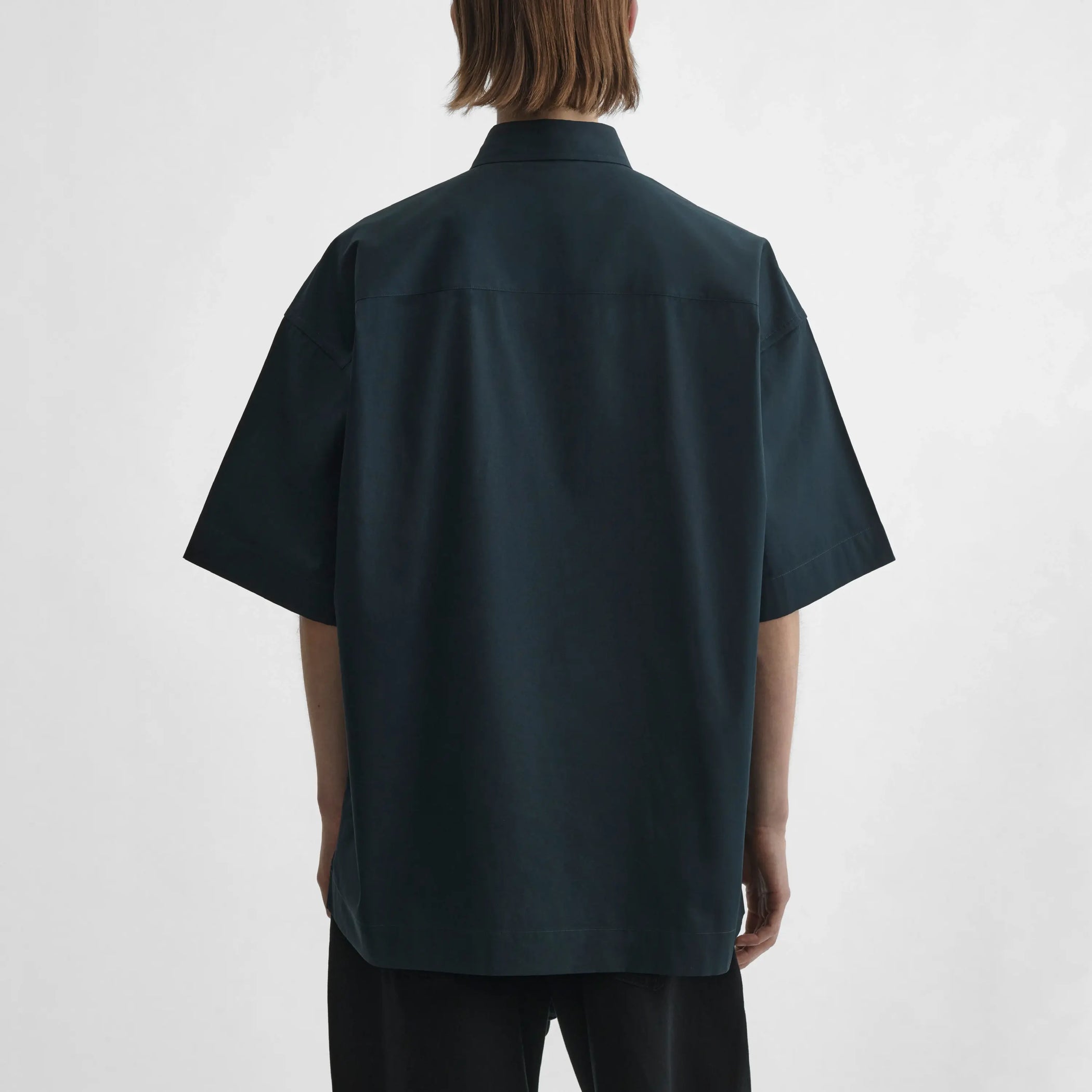 Back view of model wearing Short Sleeve Shirt in midnight.