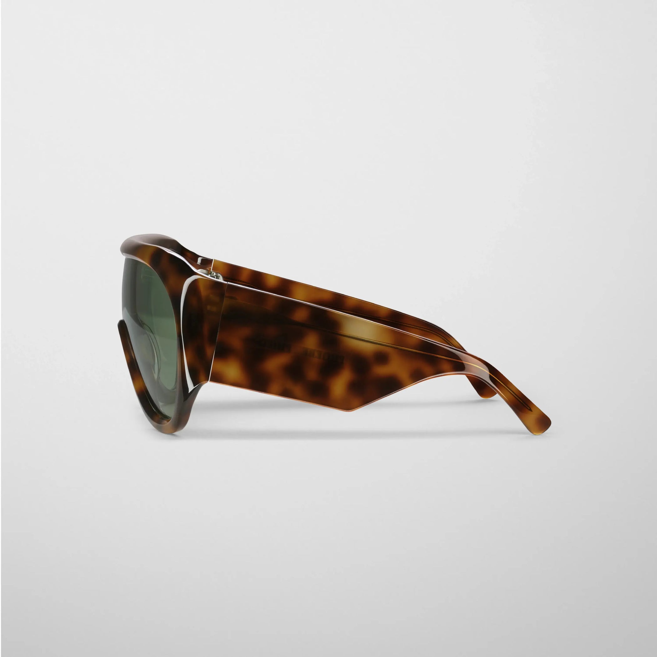 Flat side view of bombé sunglasses in cognac tortoiseshell acetate.