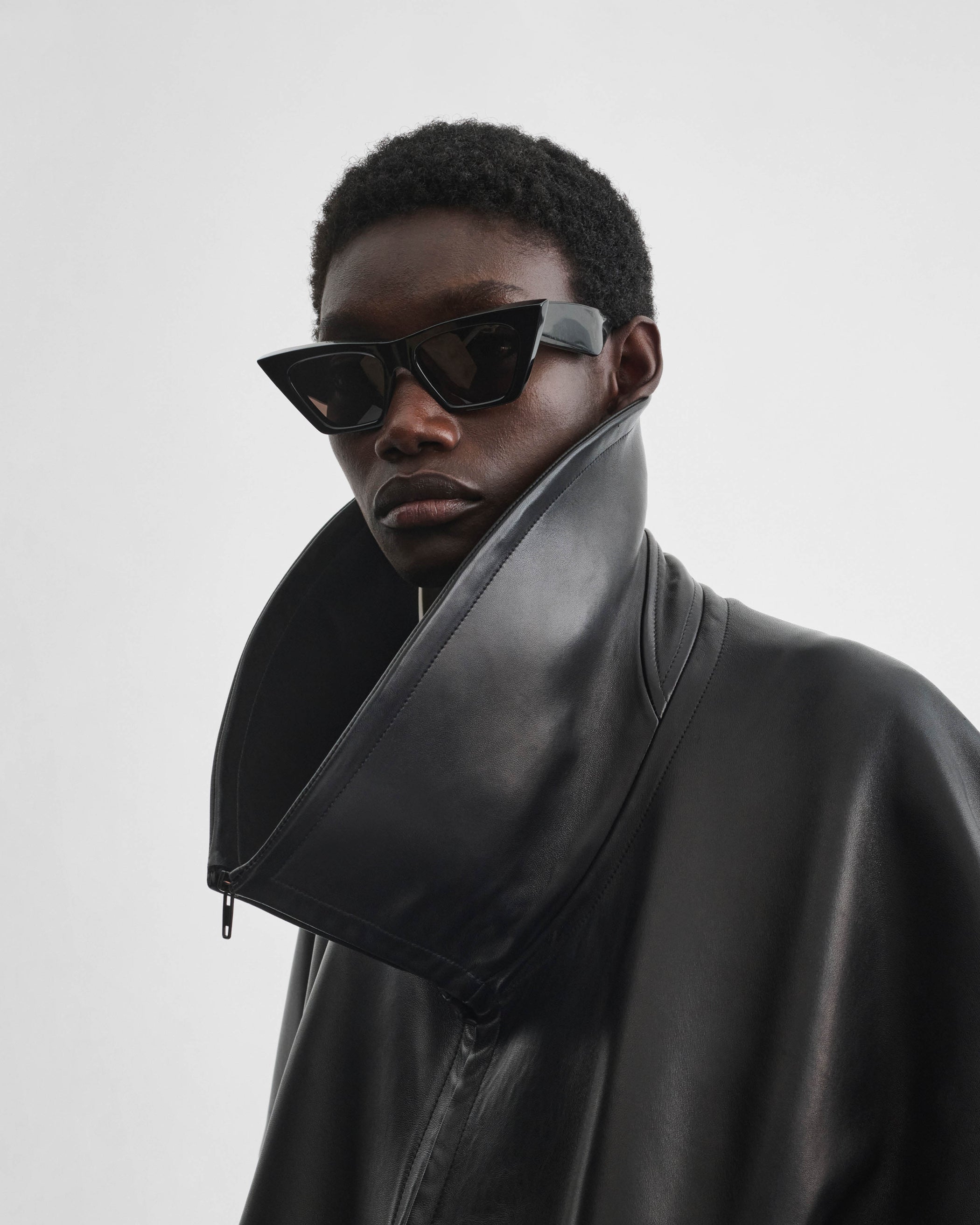 Front view of model wearing PEAK SUNGLASSES in black acetate