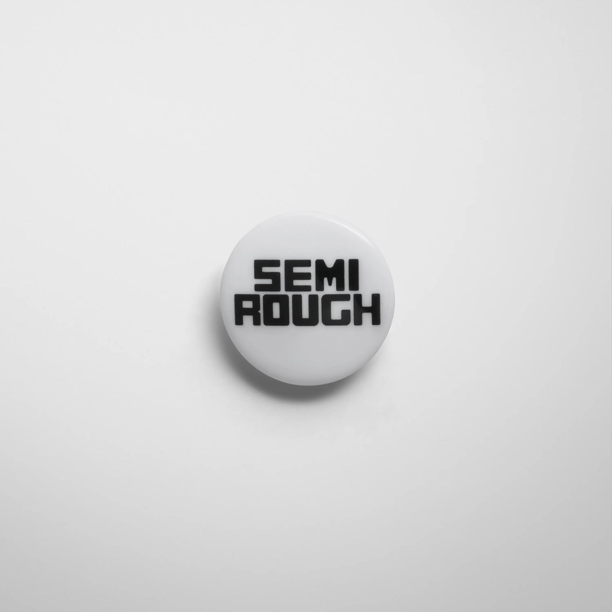 Front view of semi rough badge in black/white