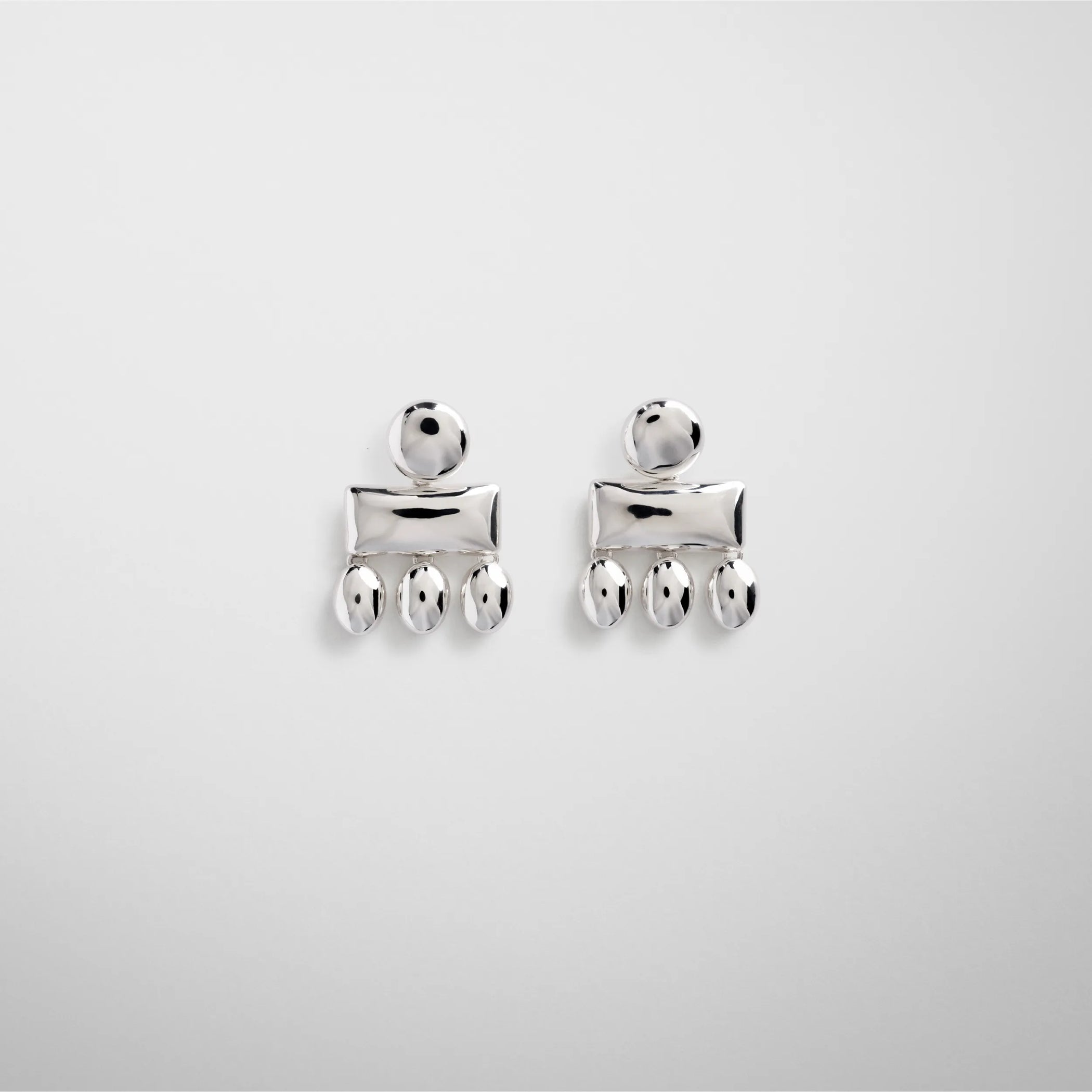 Flat front view of mini chandelier earrings in sterling silver.