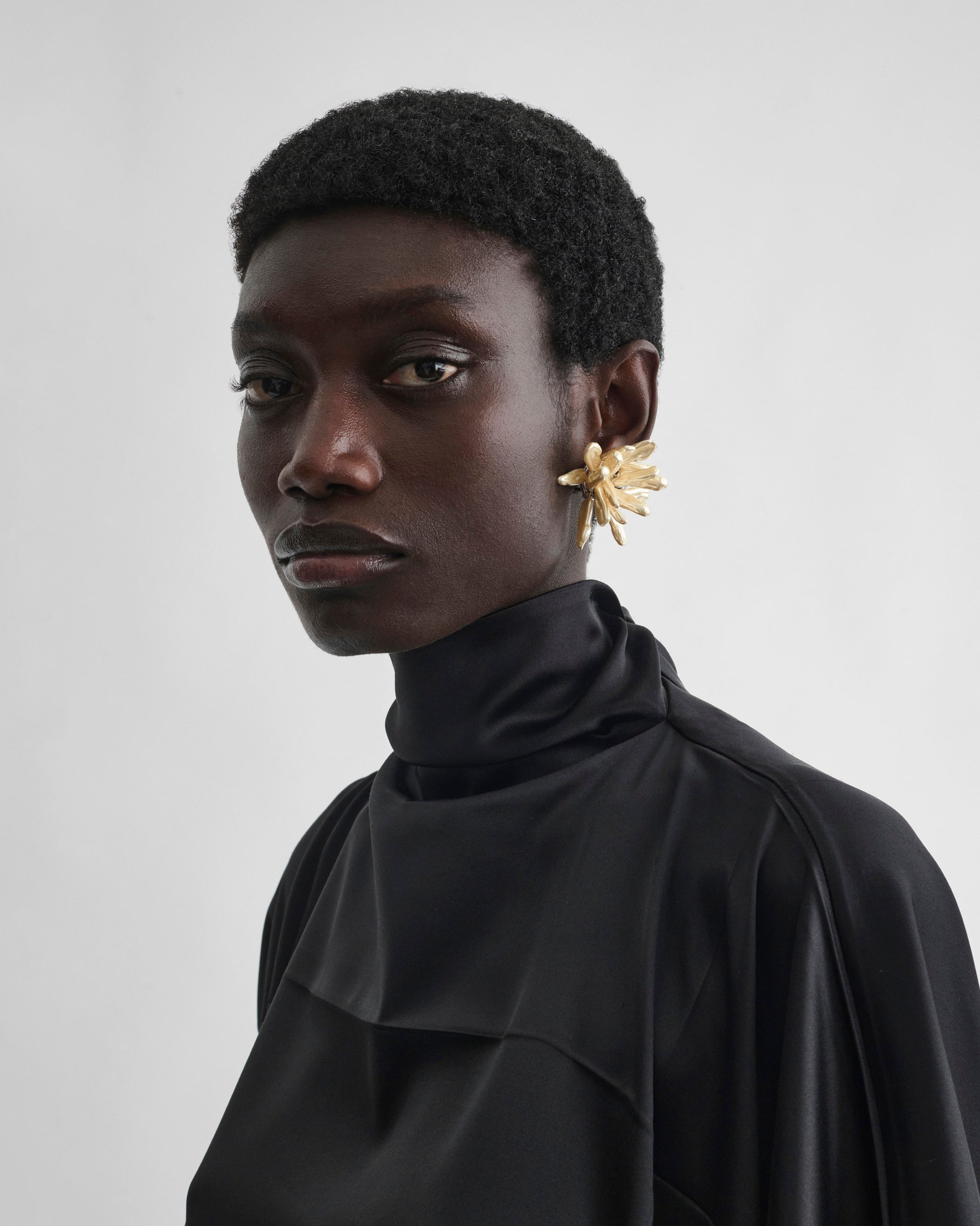 Front view of model wearing CLUSTER EARRINGS in gold