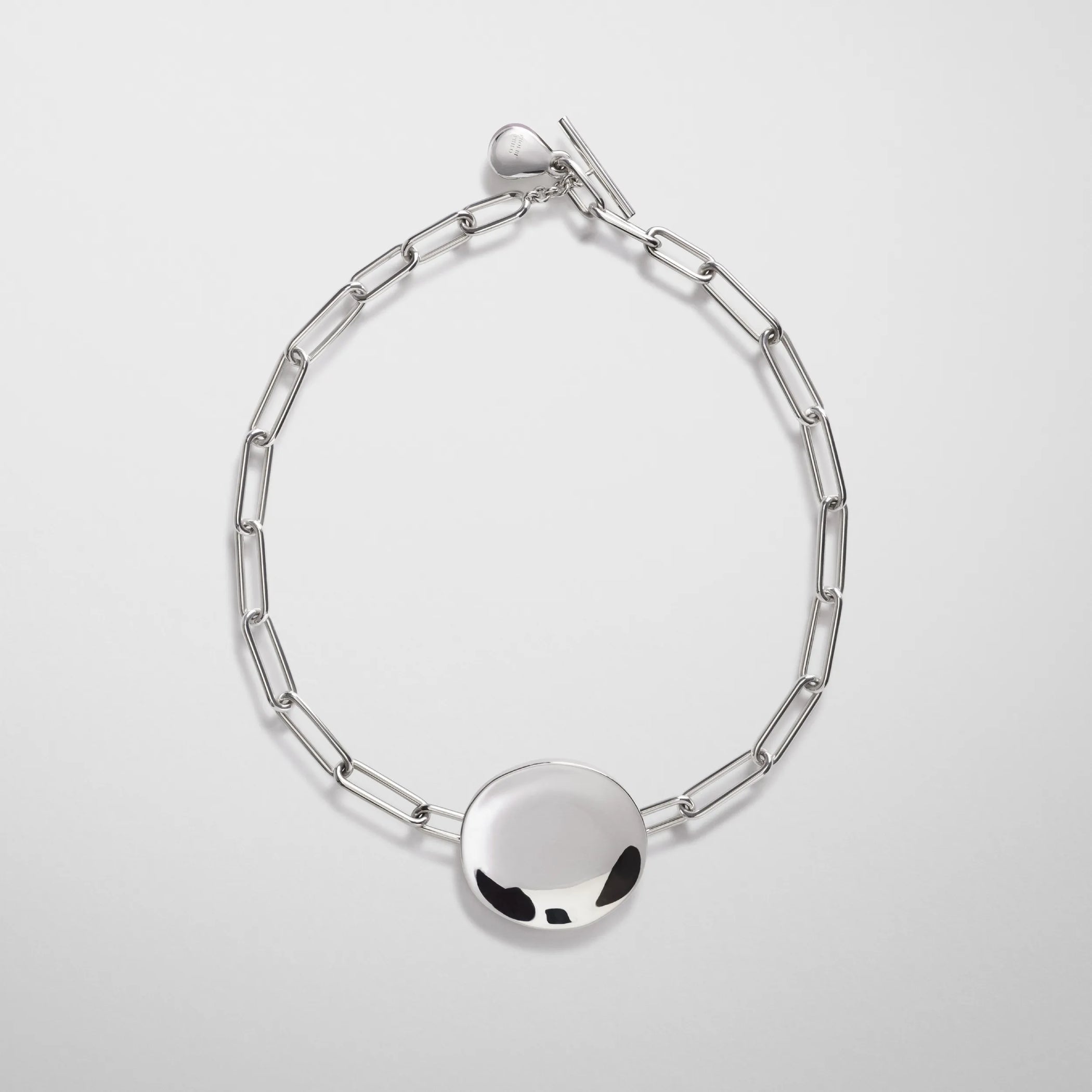 Flat front view of medallion necklace in sterling silver.