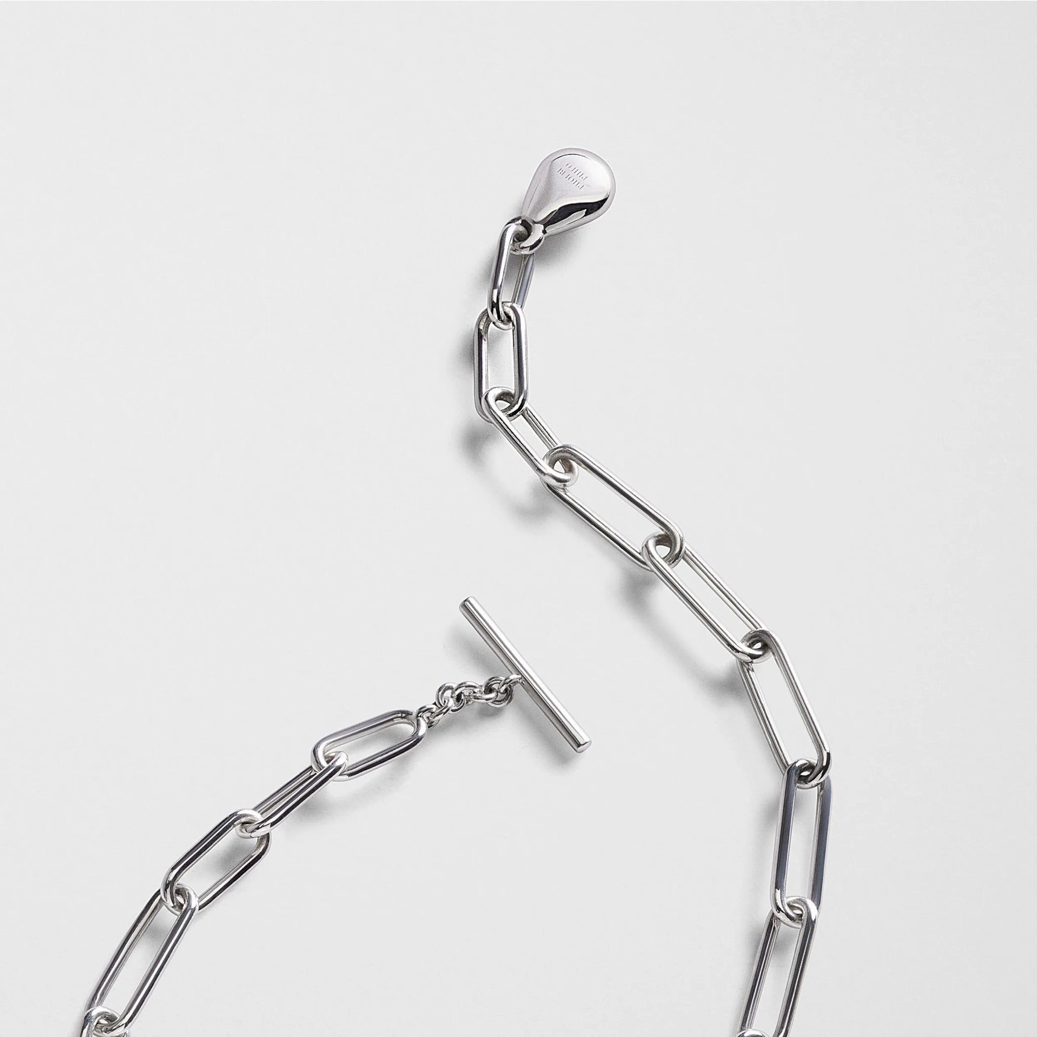 Close up detail view of medallion necklace in sterling silver.