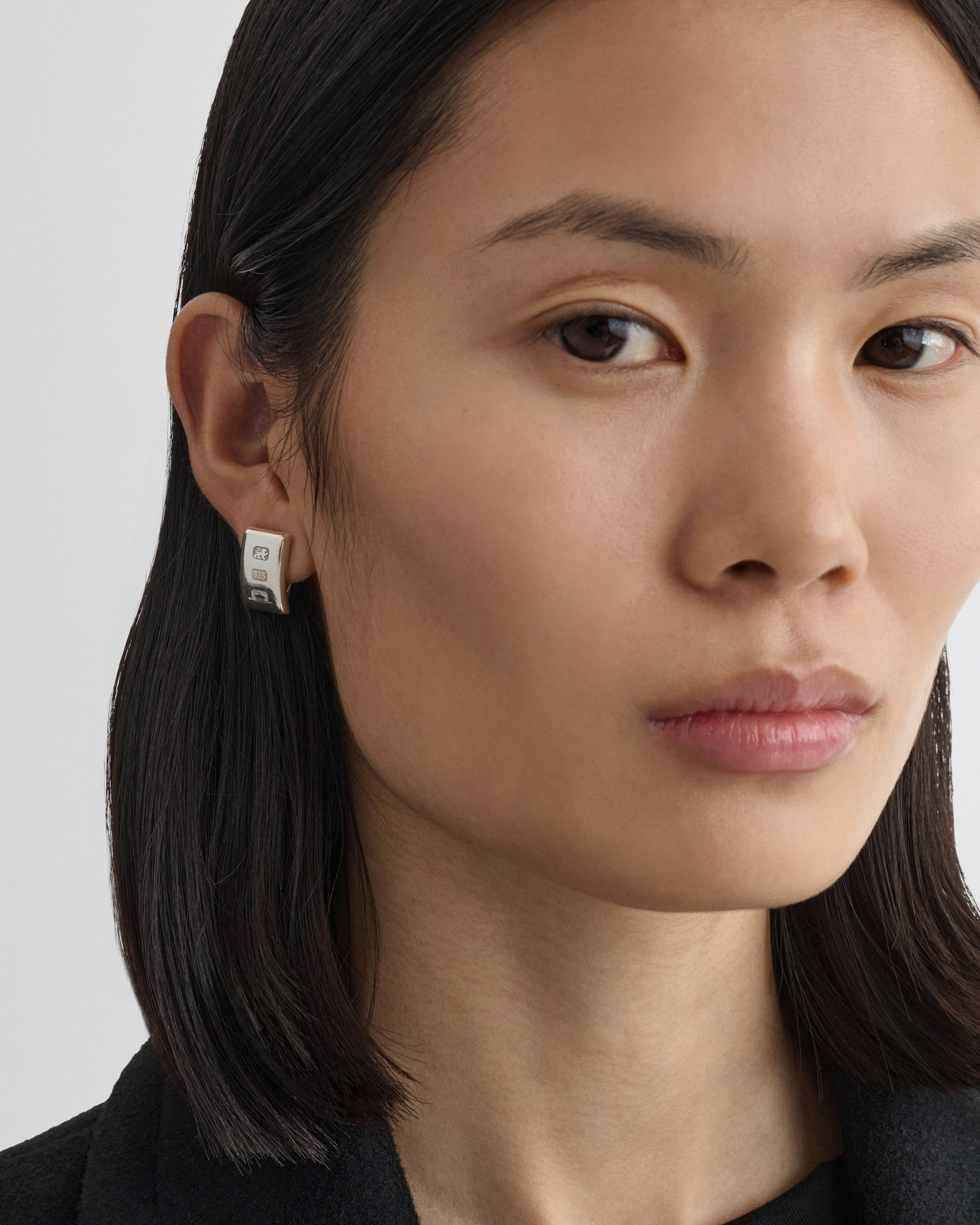 Front view of model wearing HALLMARK EARRINGS in sterling silver