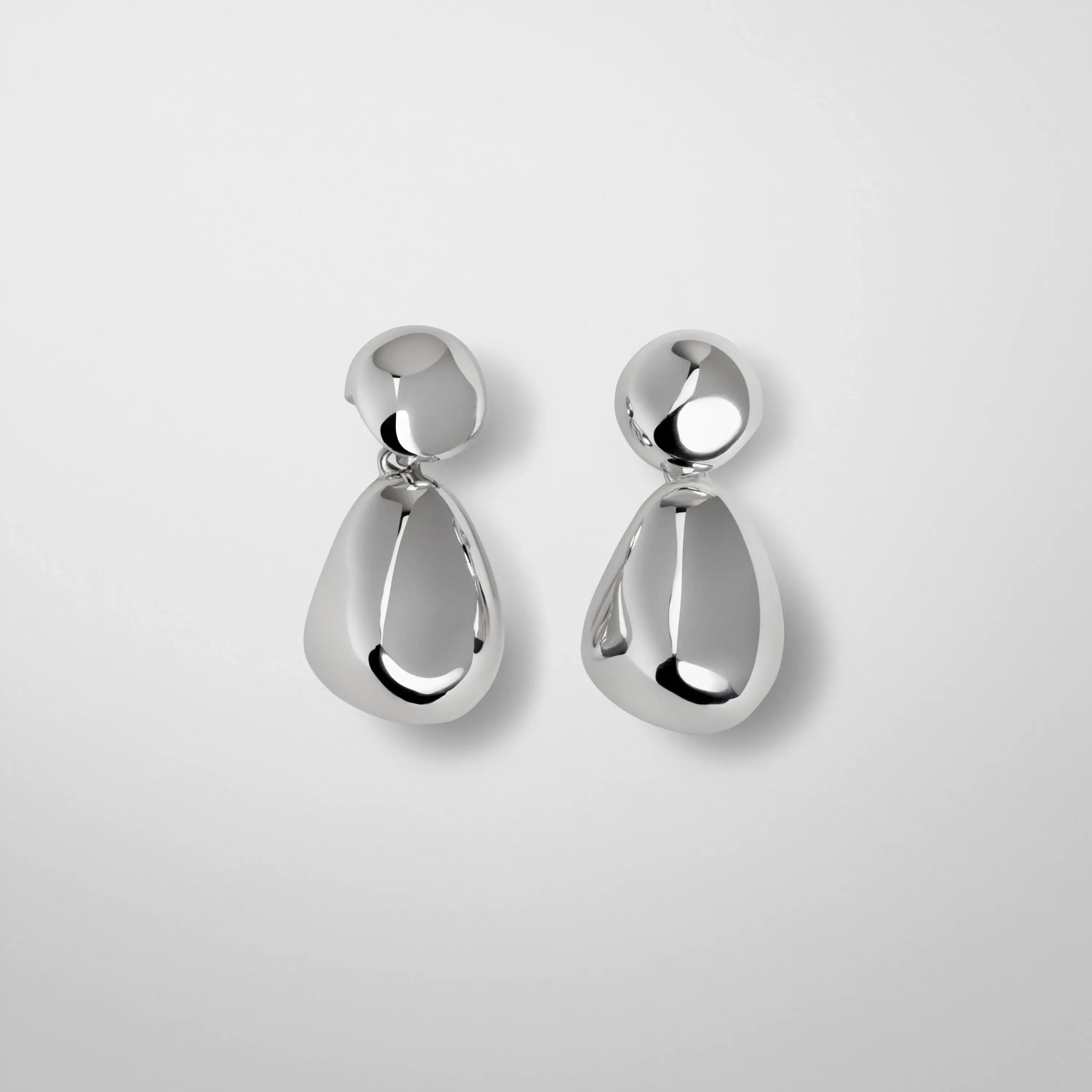 Flat lay front view of double ball earrings in silver.