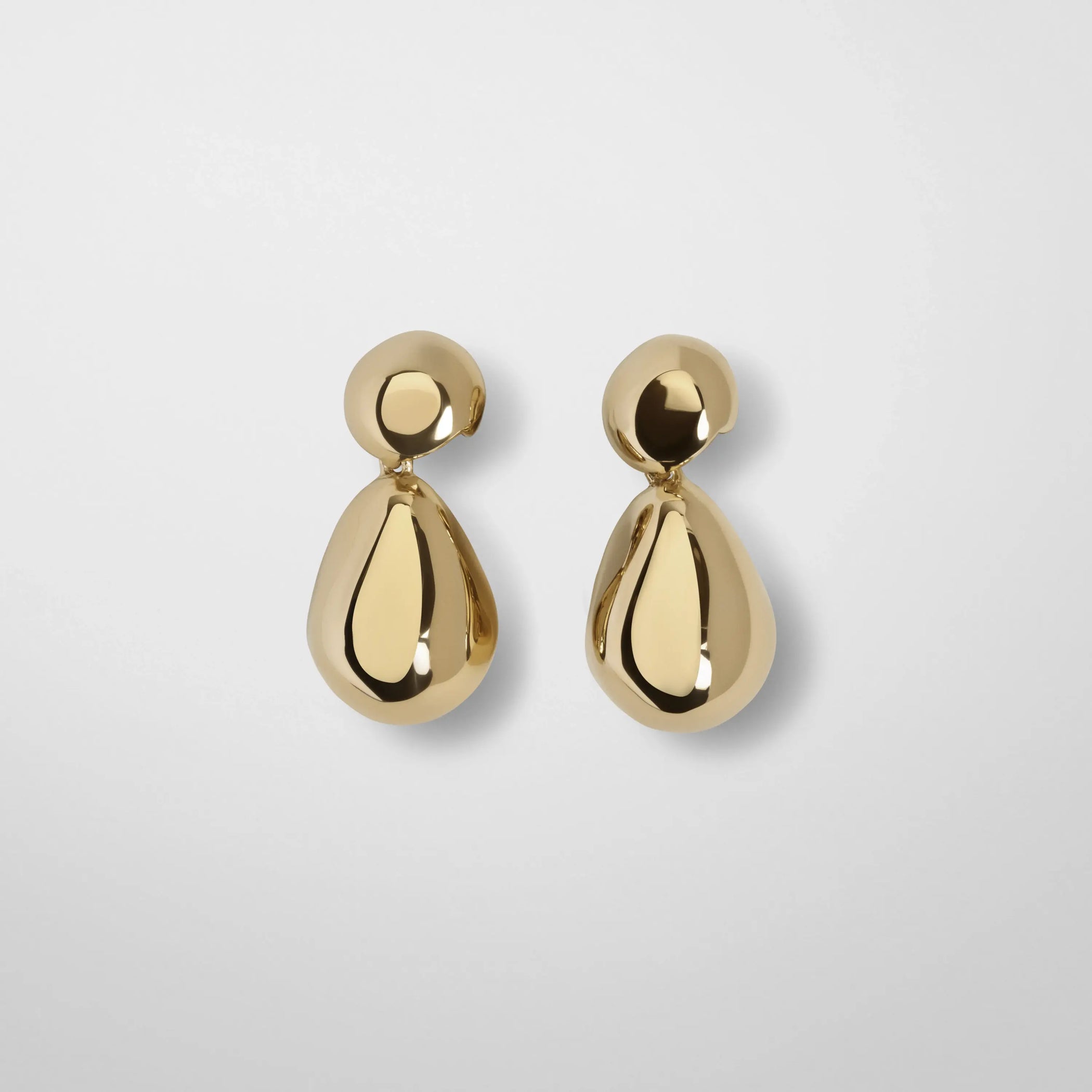 Flat lay front view of double ball earrings in gold. 