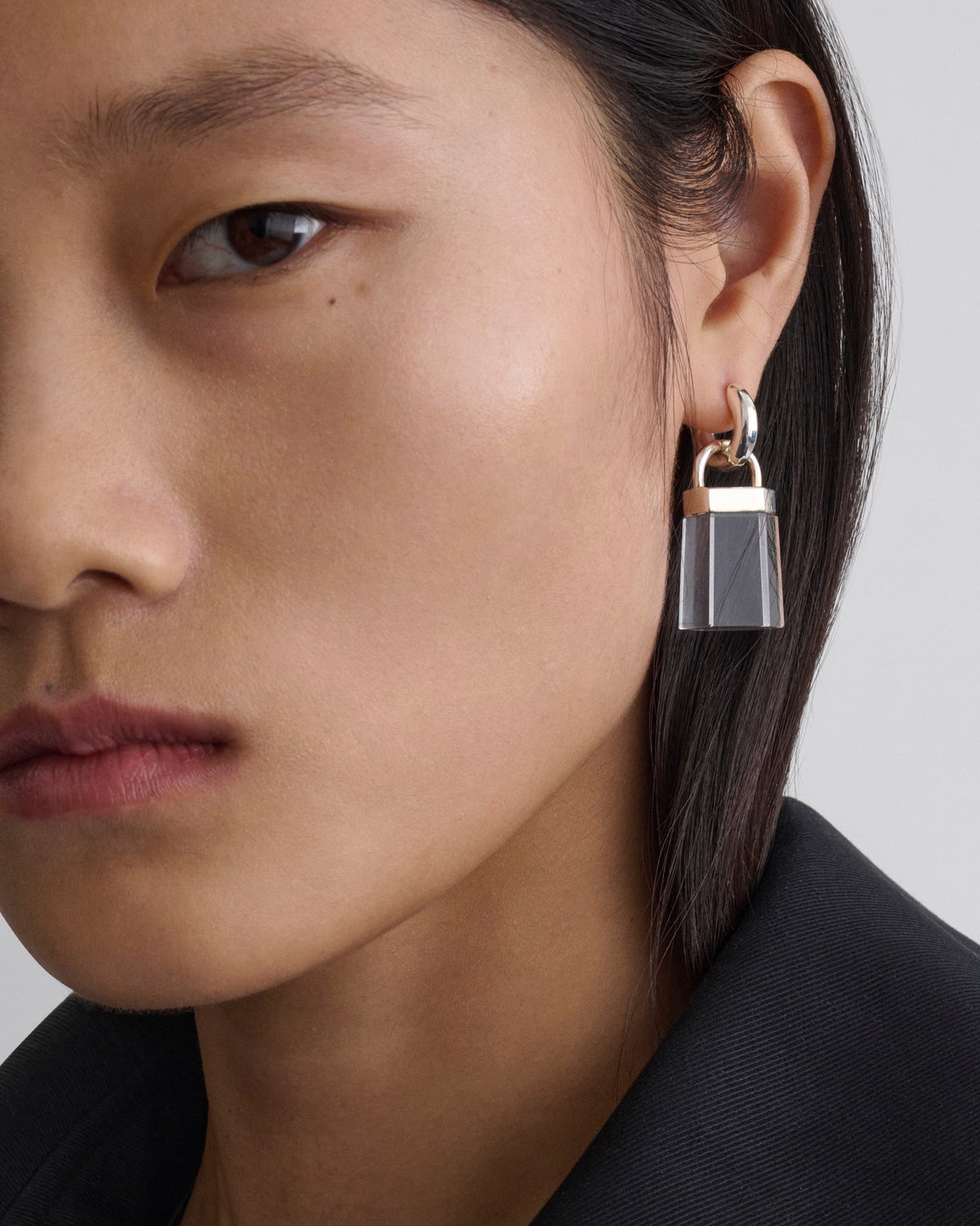Front view of model wearing PRISM EARRINGS in clear resin sterling silver