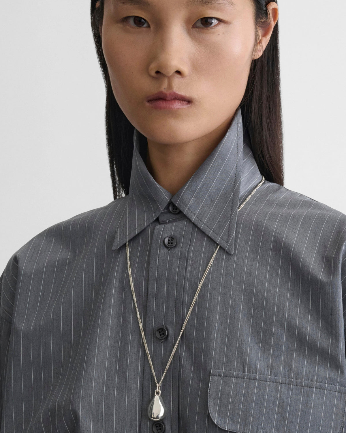 Front view of model wearing SMALL PEBBLE PENDANT in sterling silver