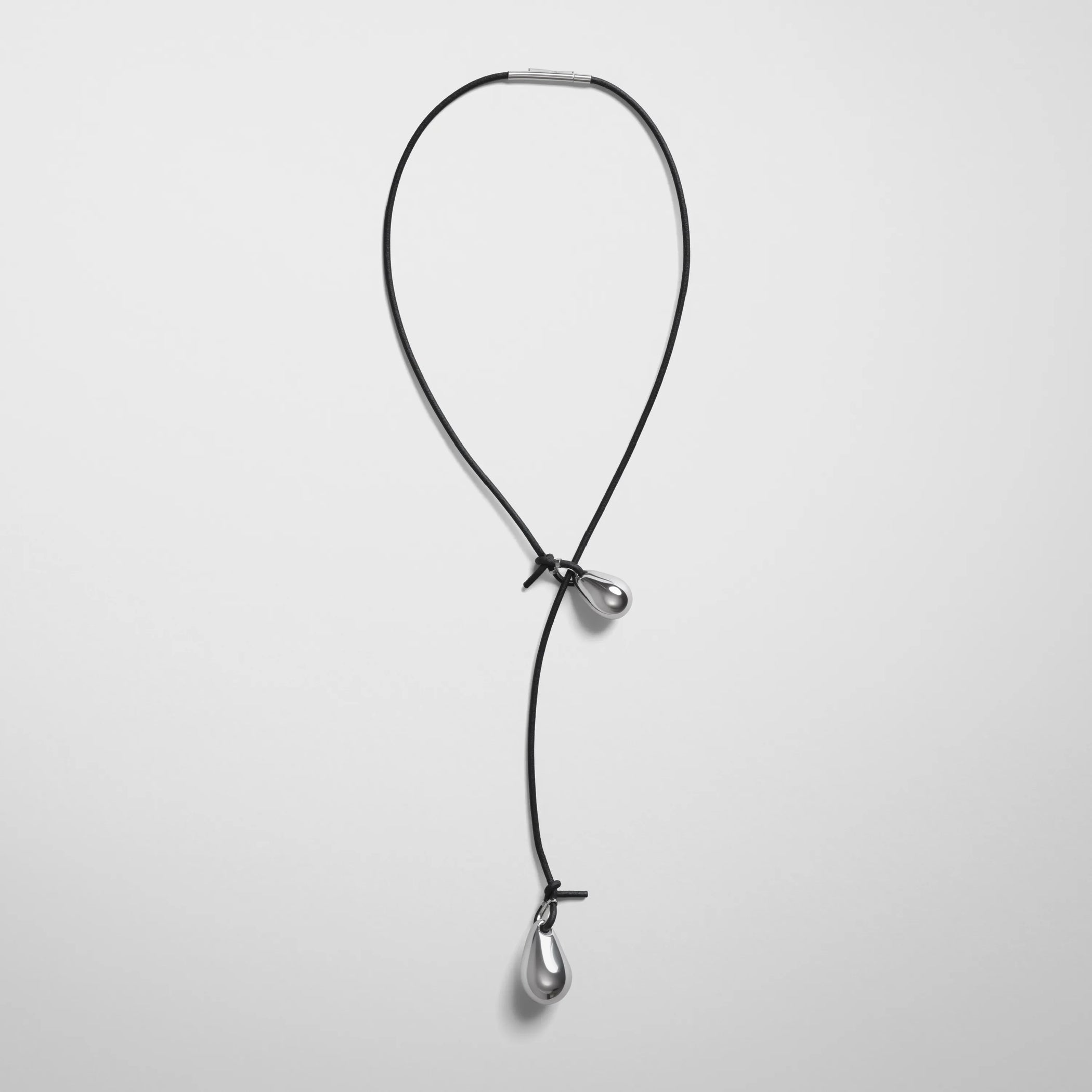 Flat front view of pebble duo pendant in sterling silver