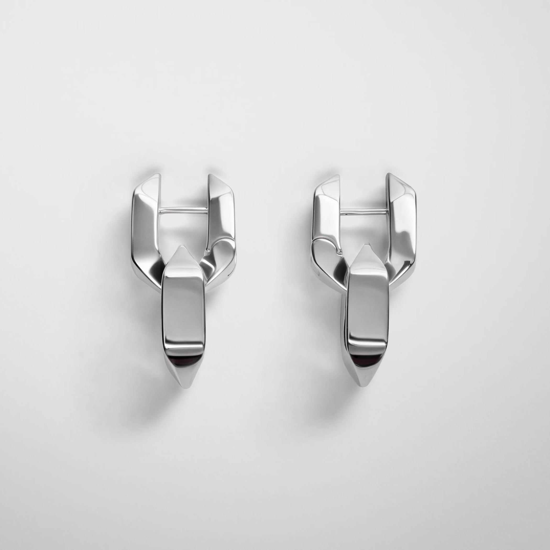 Flat lay front view of Chain Link Earrings in sterling silver.
