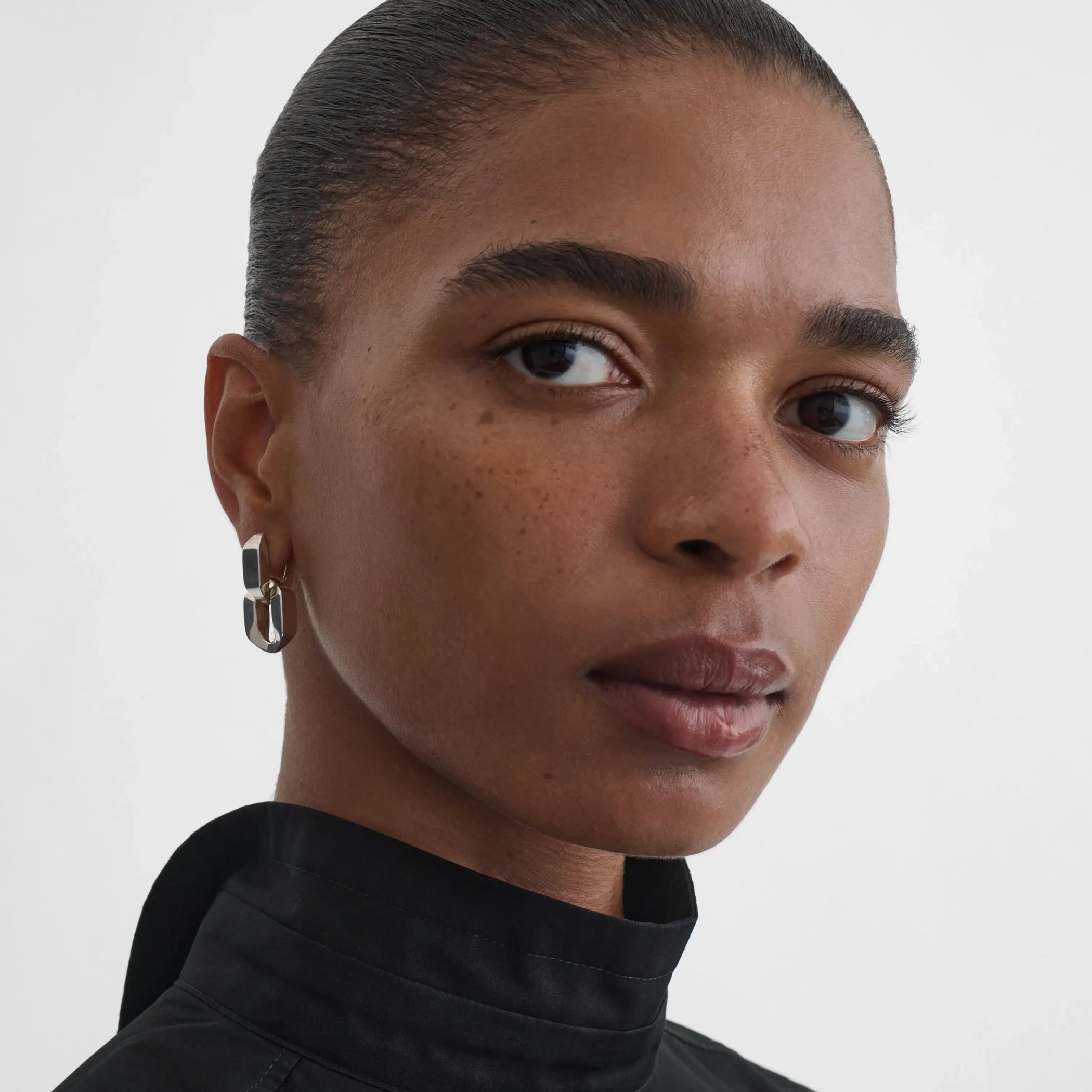 Front view of model wearing Chain Link Earrings in sterling silver.