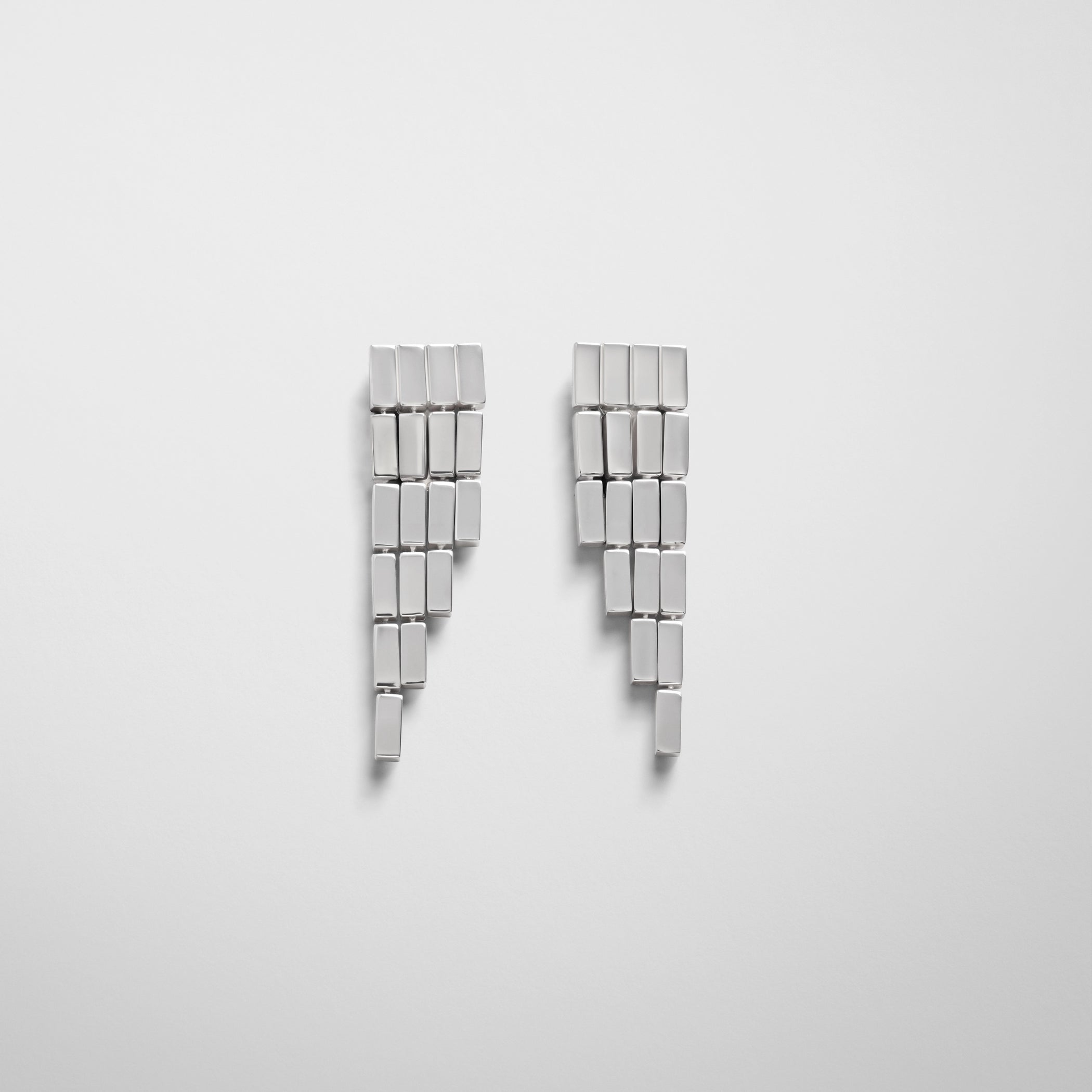 Front view of geometric cascade earrings in sterling silver