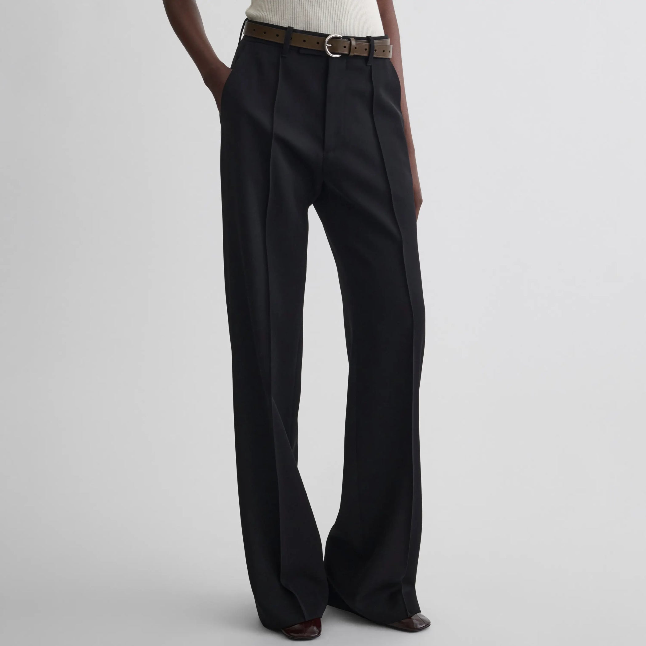 Front view of model wearing Boyish Tailored Trousers in black.