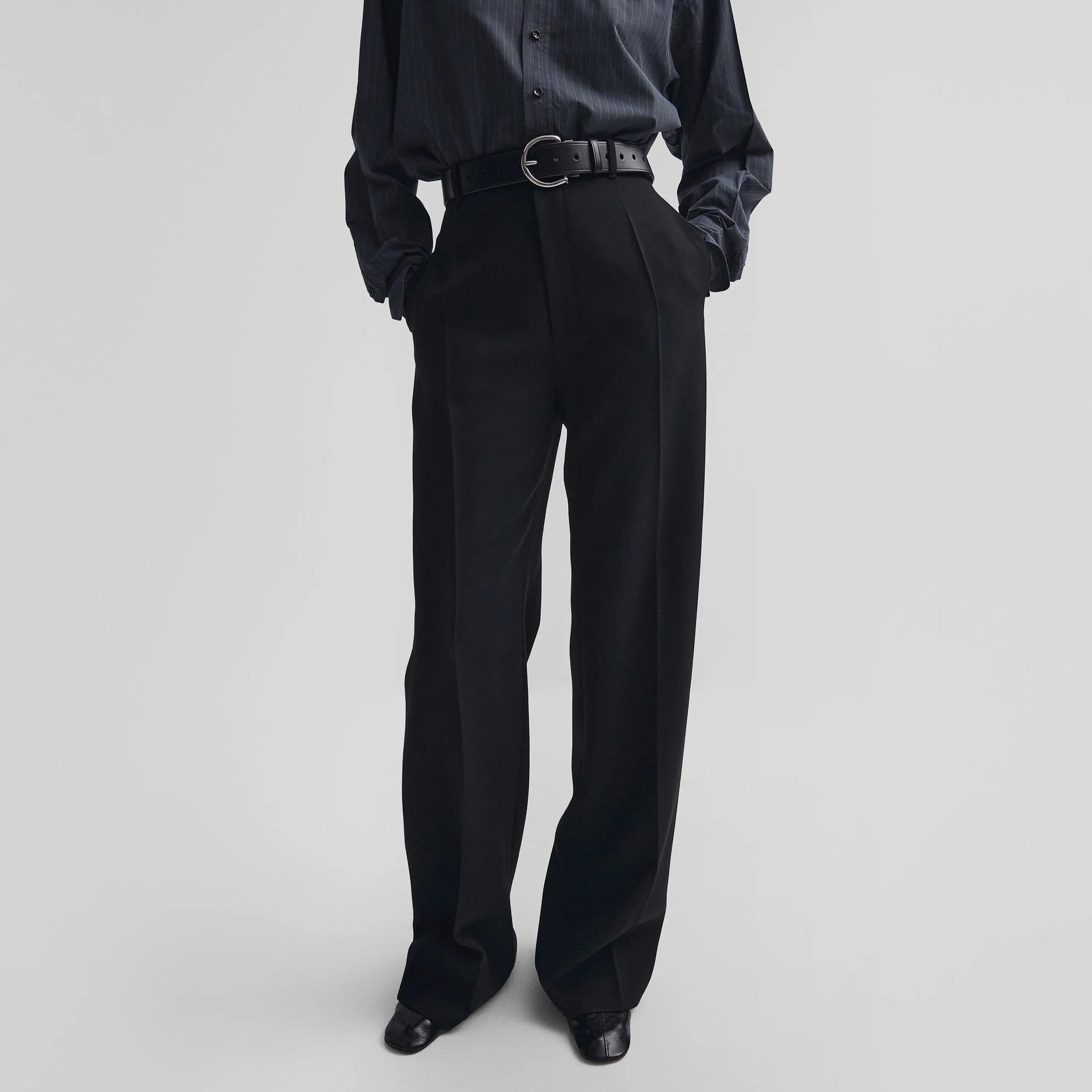 Front view of zip trousers in black wool