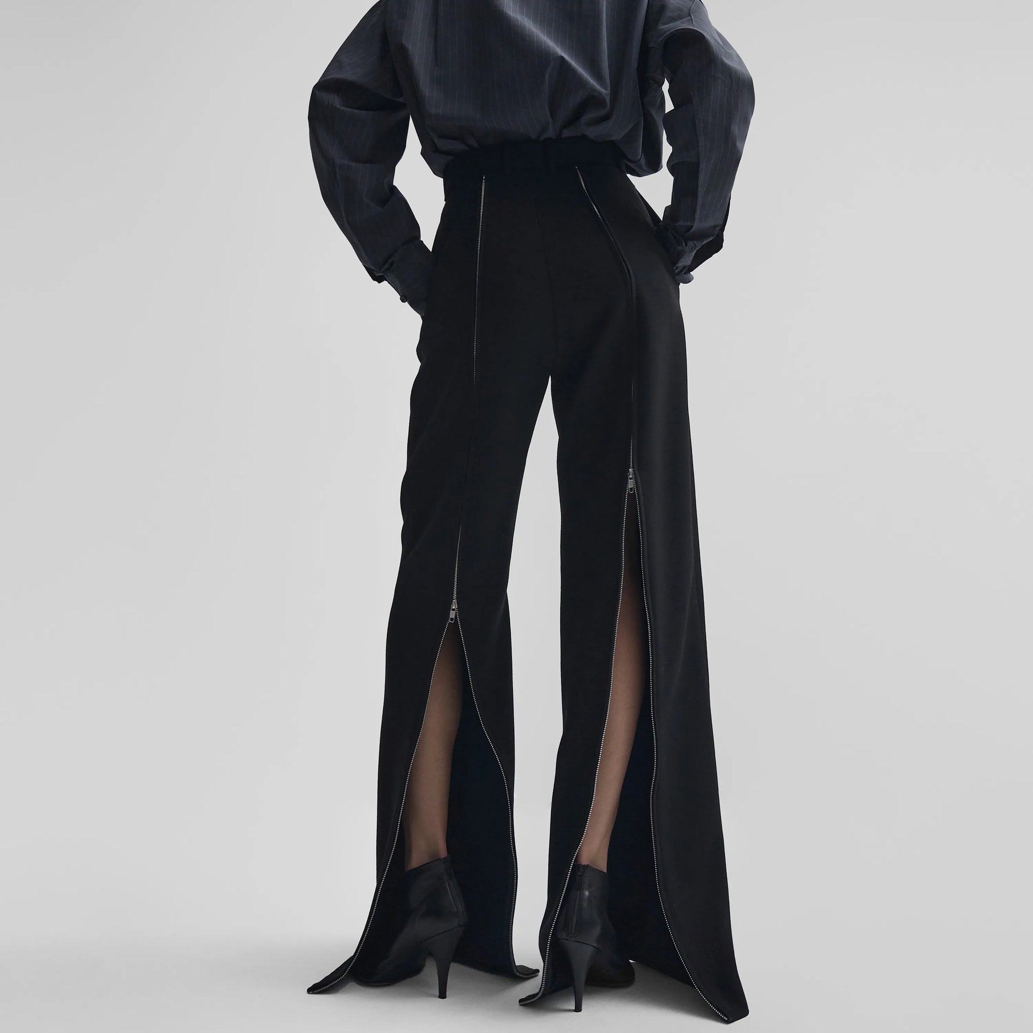 Back view of zip trousers in black wool