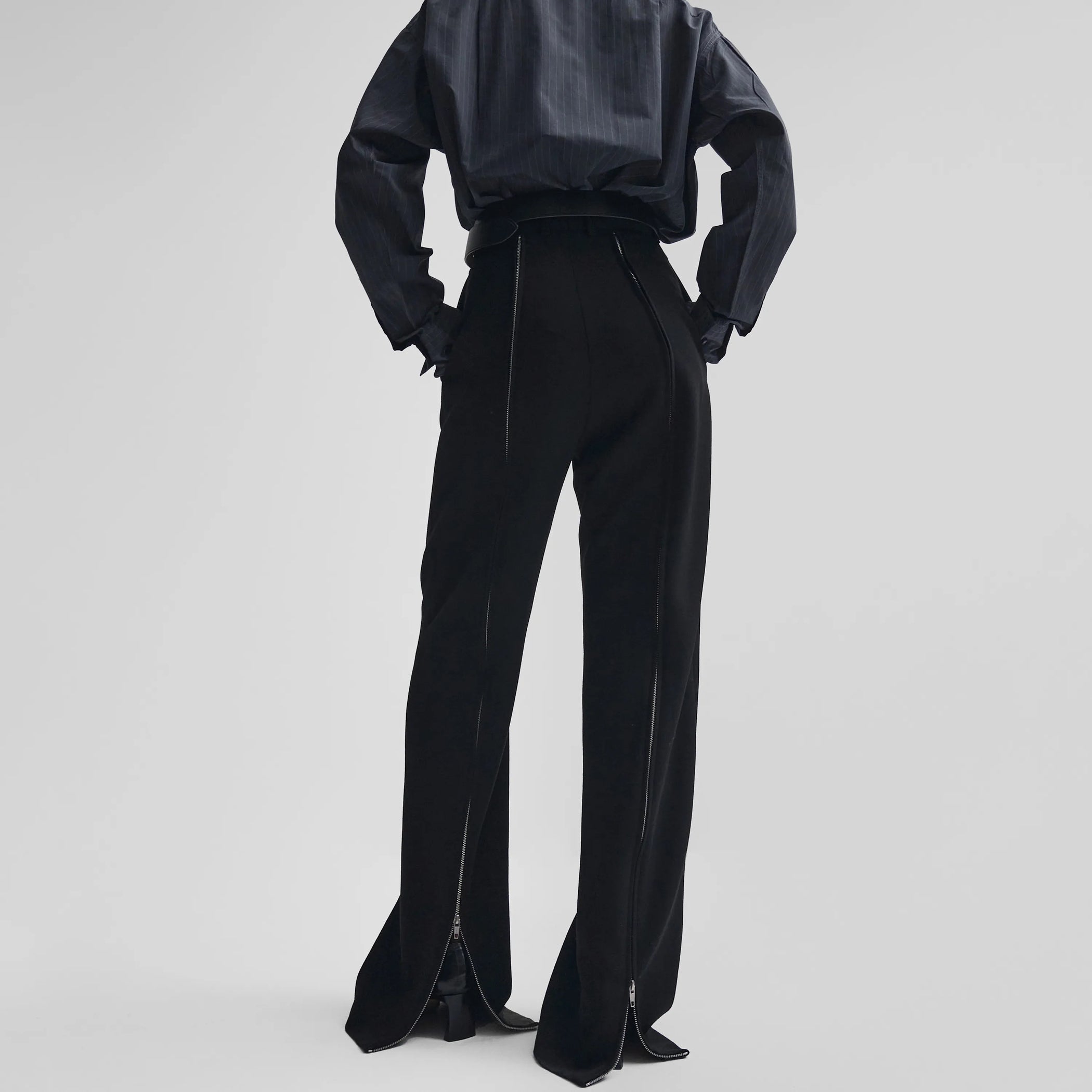 Back view of zip trousers in black wool