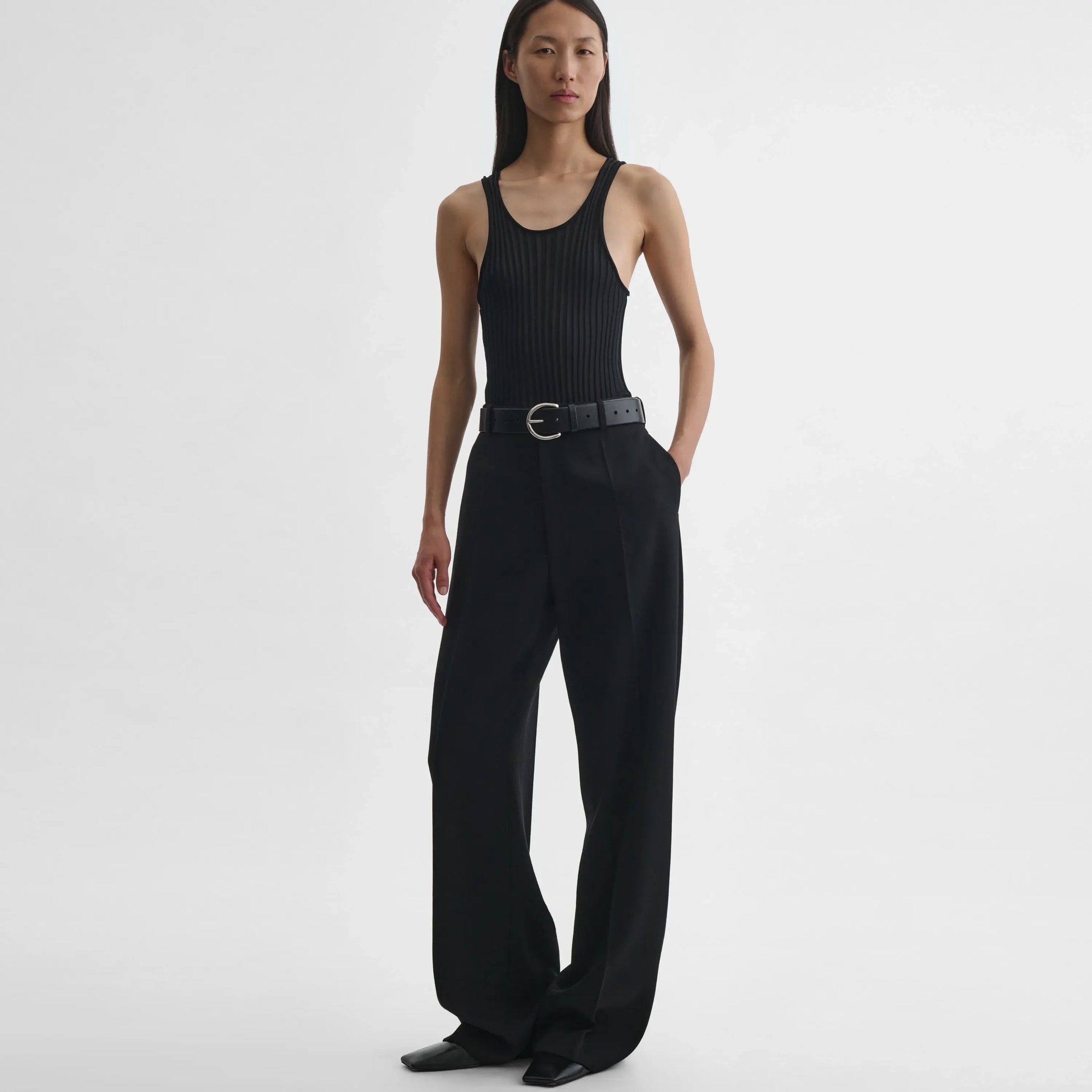Front full body view of model wearing milanese trousers in black wool.