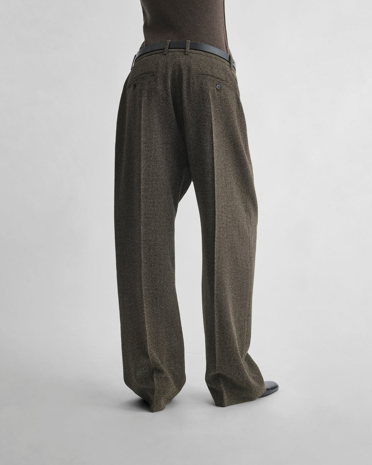 Back view of model wearing DROP TROUSERS in khaki/white wool