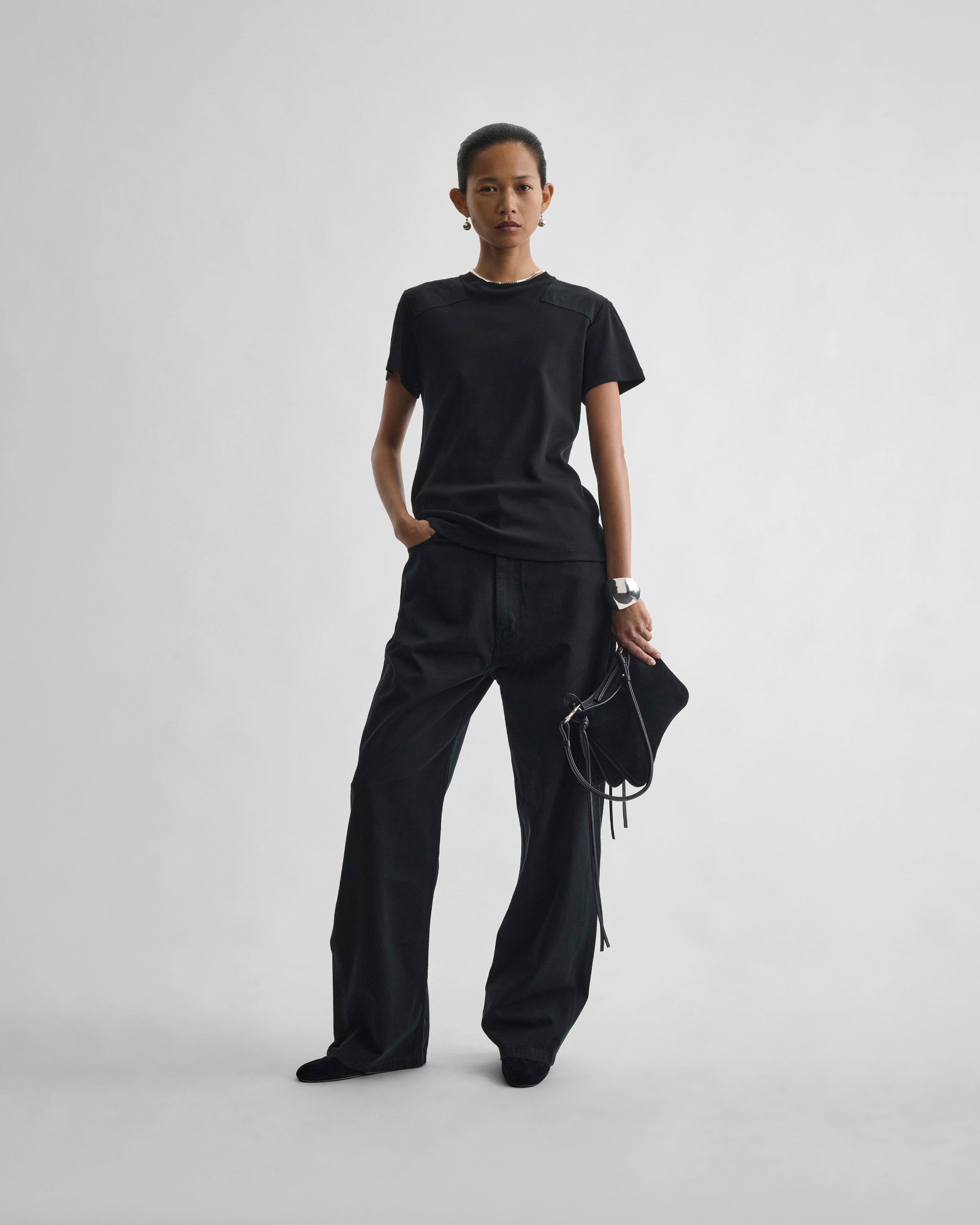 Front view of model wearing DROP JEANS in black cotton