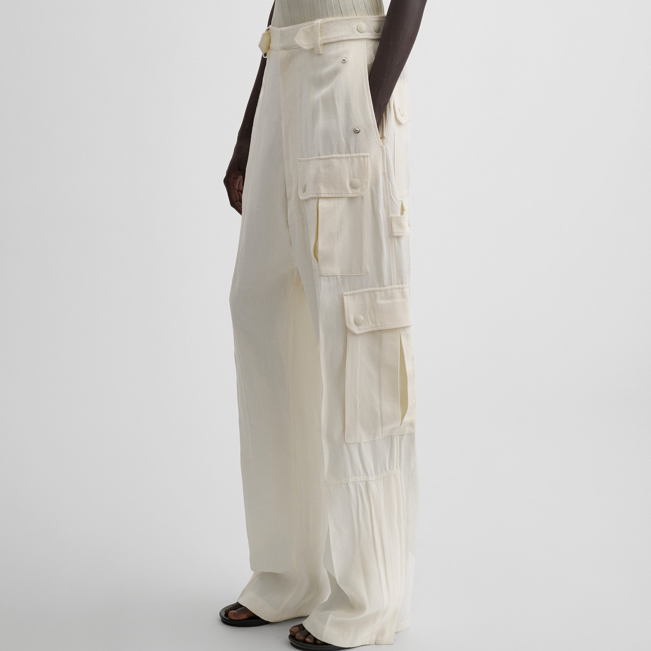 Side view of model wearing PATCH POCKET CARGO TROUSERS in parchment viscose silk