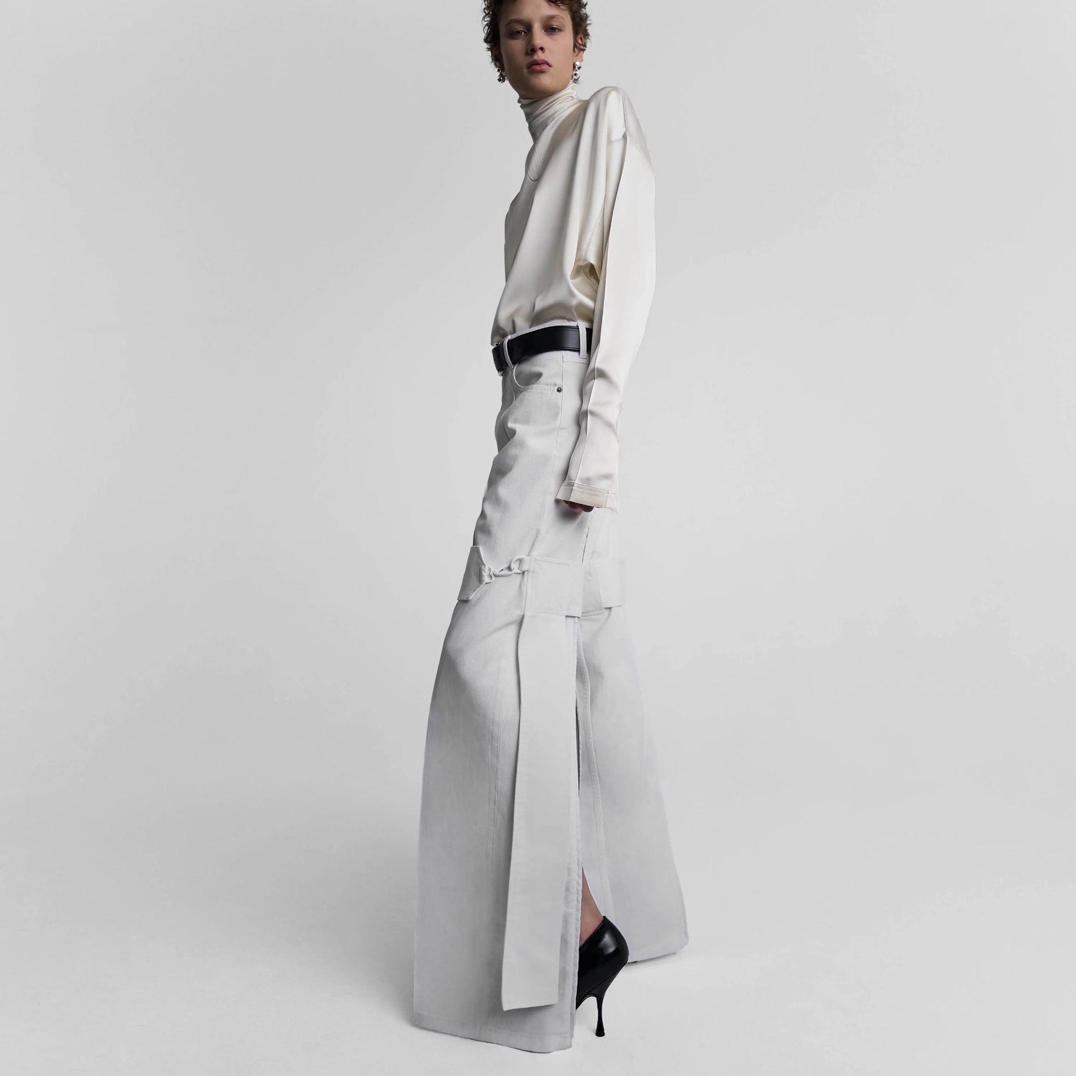 Side view of strap jeans in chalk white denim