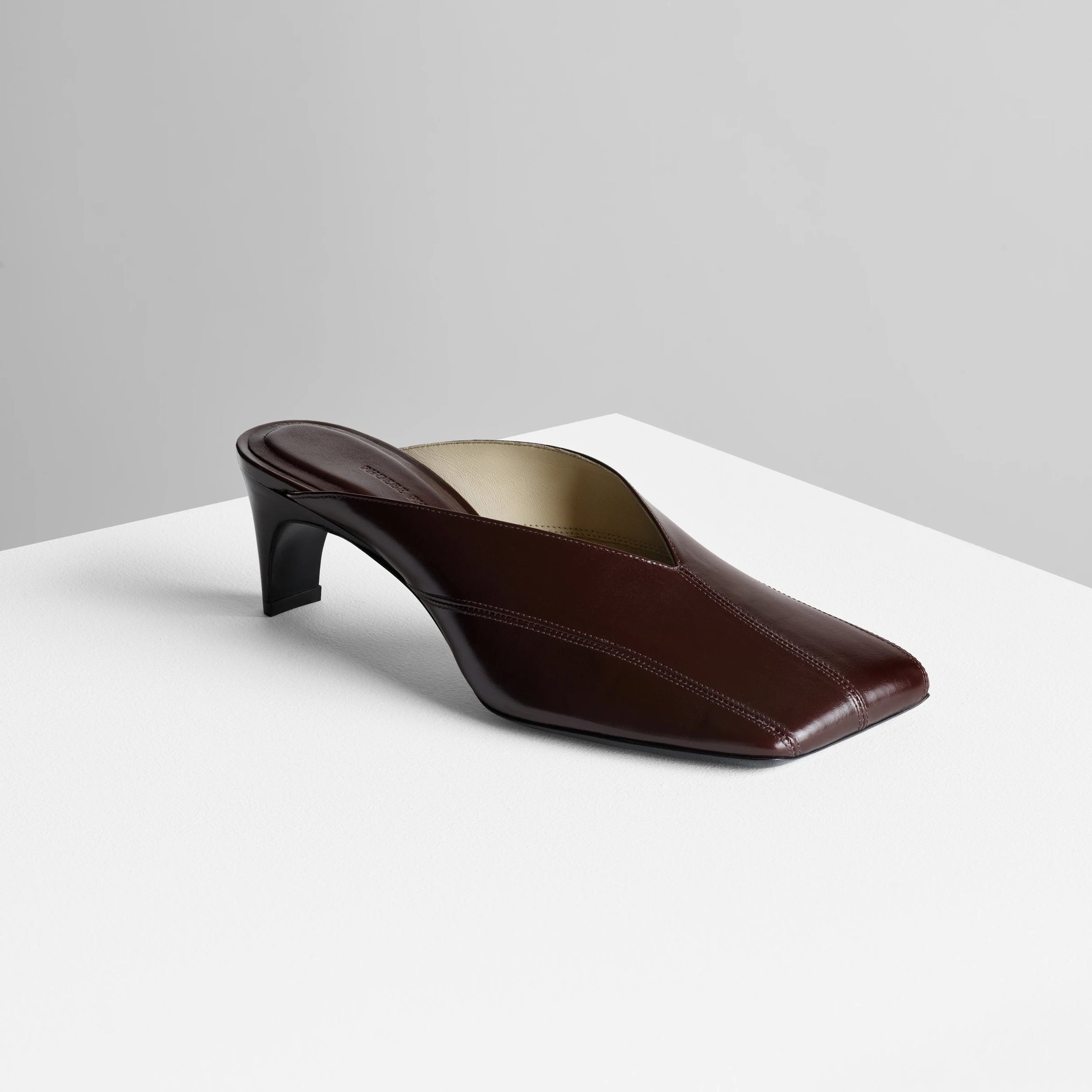 Side view of tilt mule in oxblood leather.